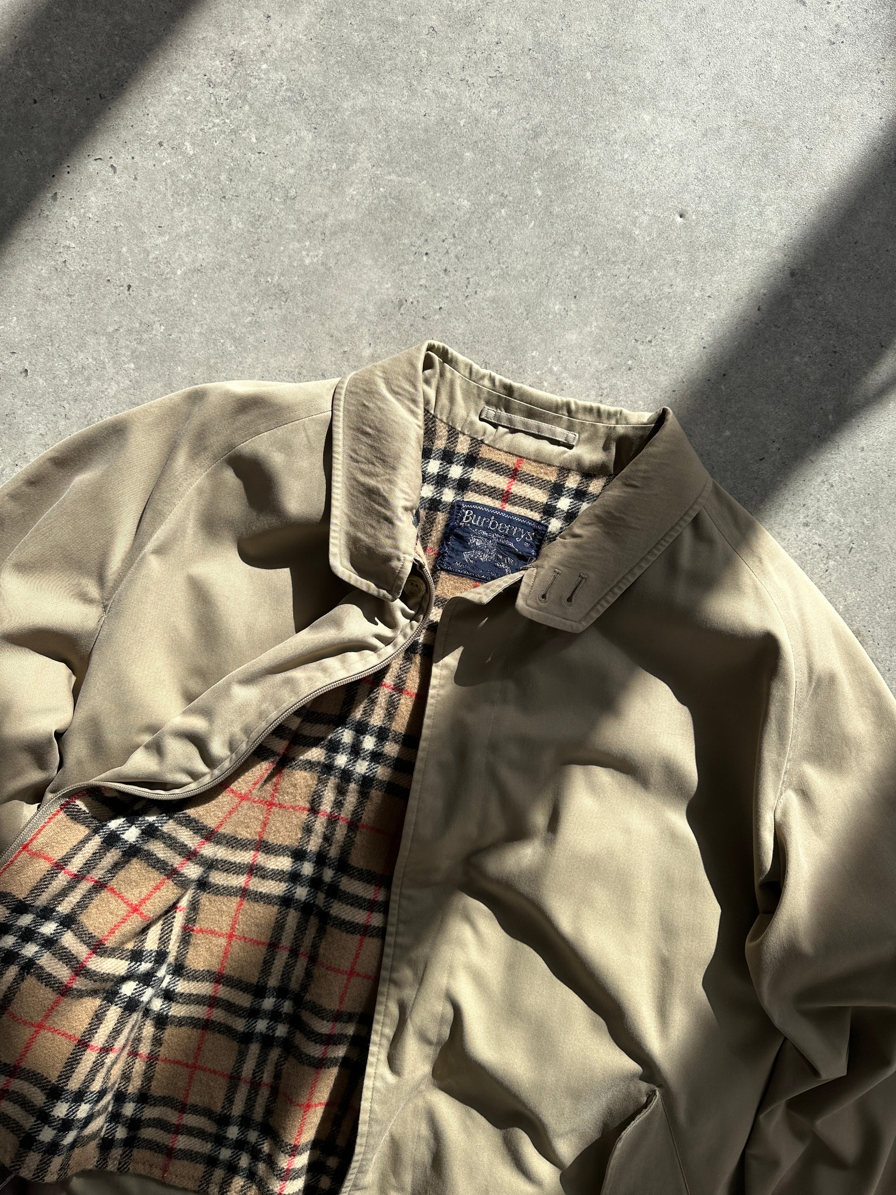 Burberry Nova Check bomber jacket in size L, featuring classic check pattern, ribbed cuffs, and front zip closure.
