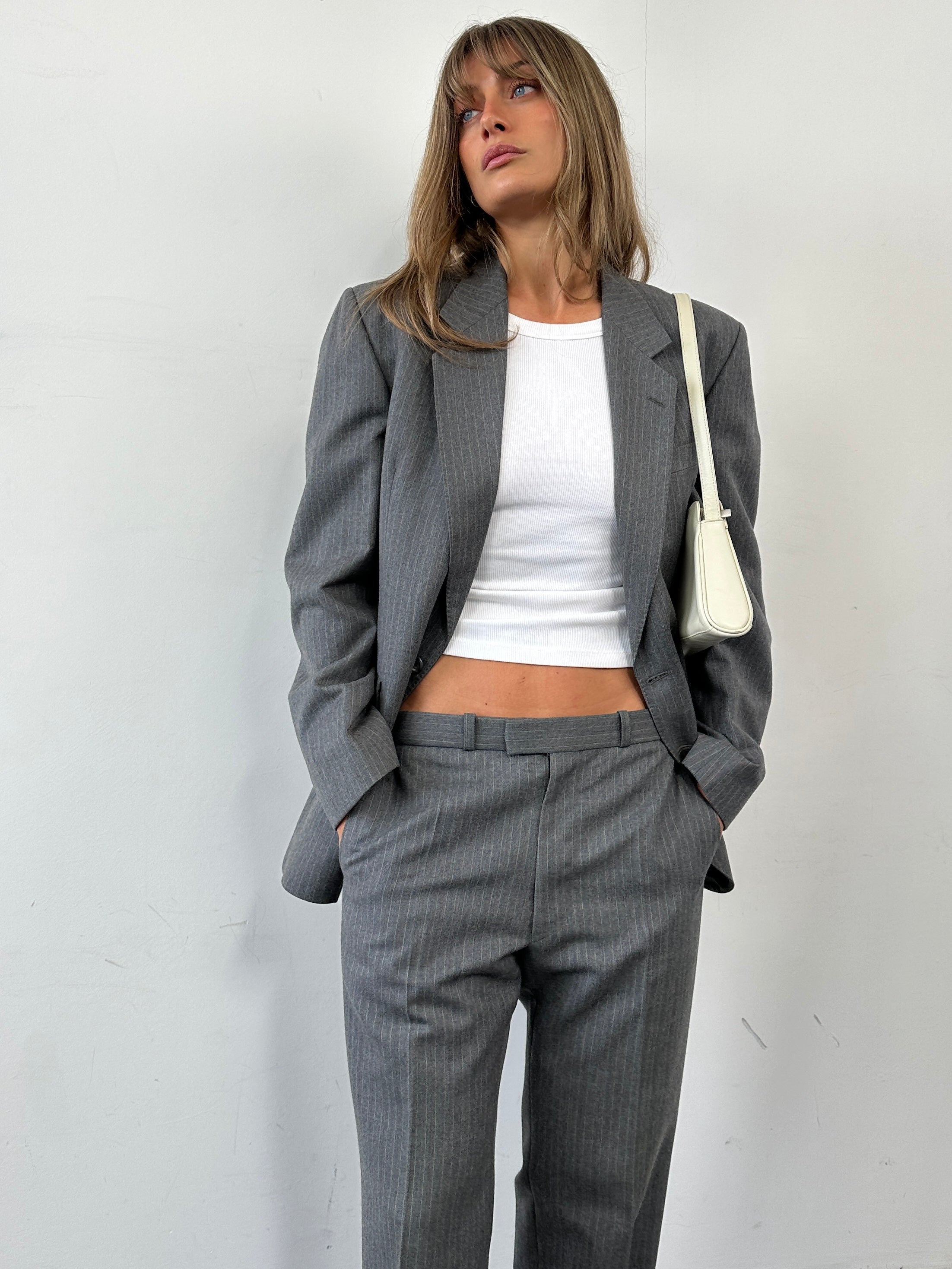 Vintage British pinstripe wool jumpsuit, single-breasted suit in size 42R/W32, featuring classic tailored style and vintage fabric.