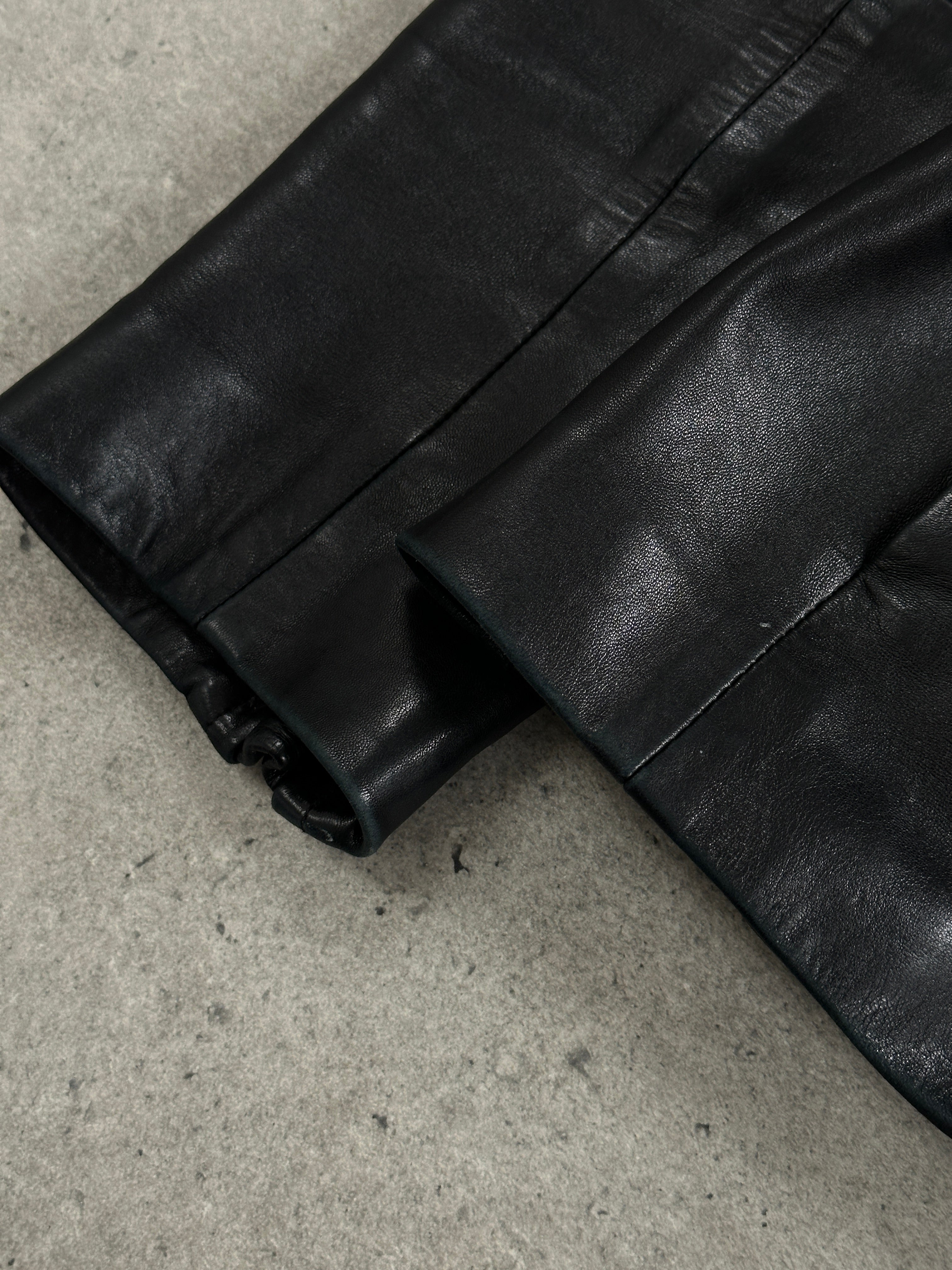 Vintage French 1990s high neck leather jacket with tie belt, showcasing a classic 1990s style and high neckline detail.