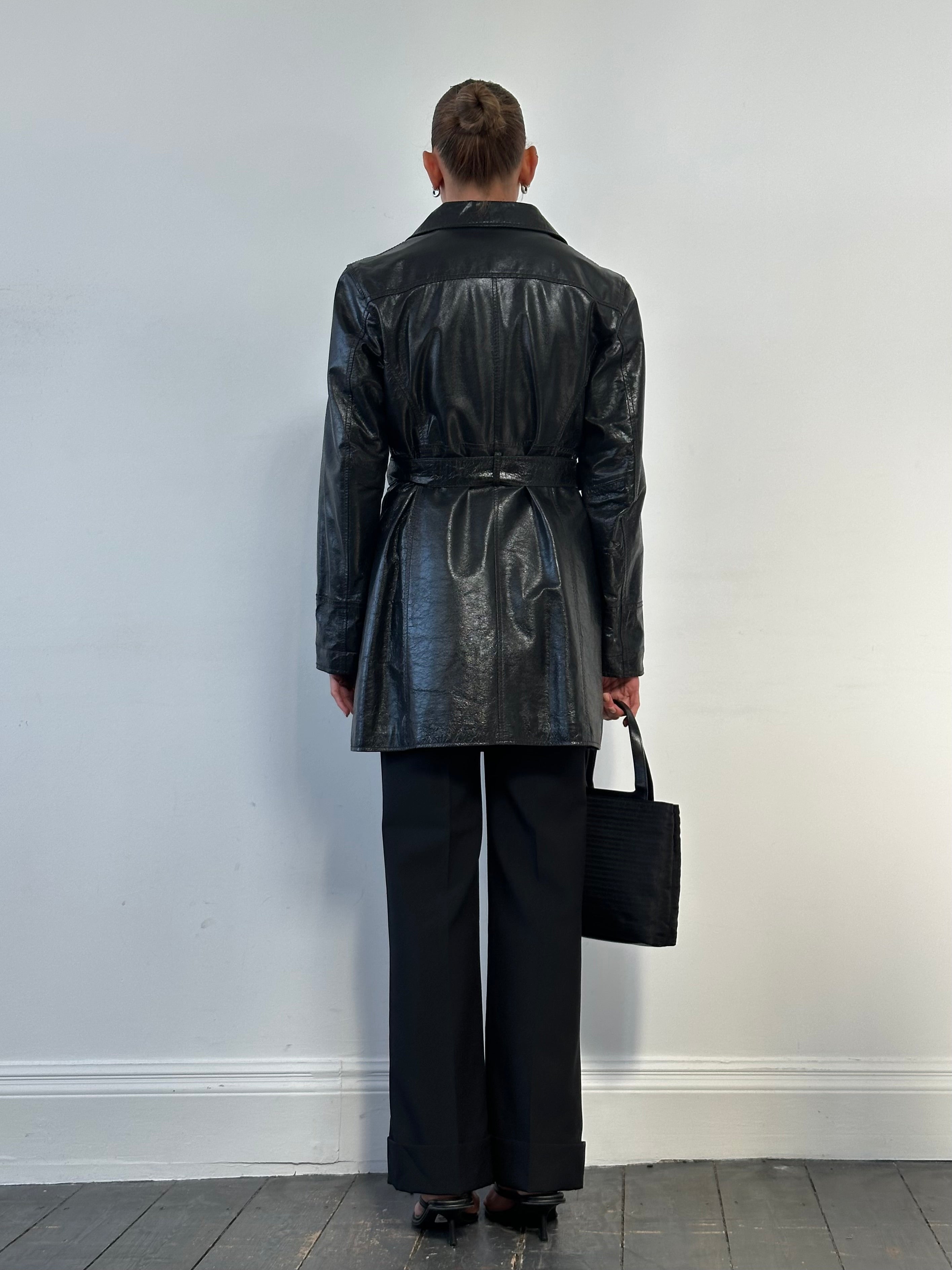 Conbipel leather belted trench coat in size M, stylish jacket with a classic design and belt detail, displayed on a hanger.