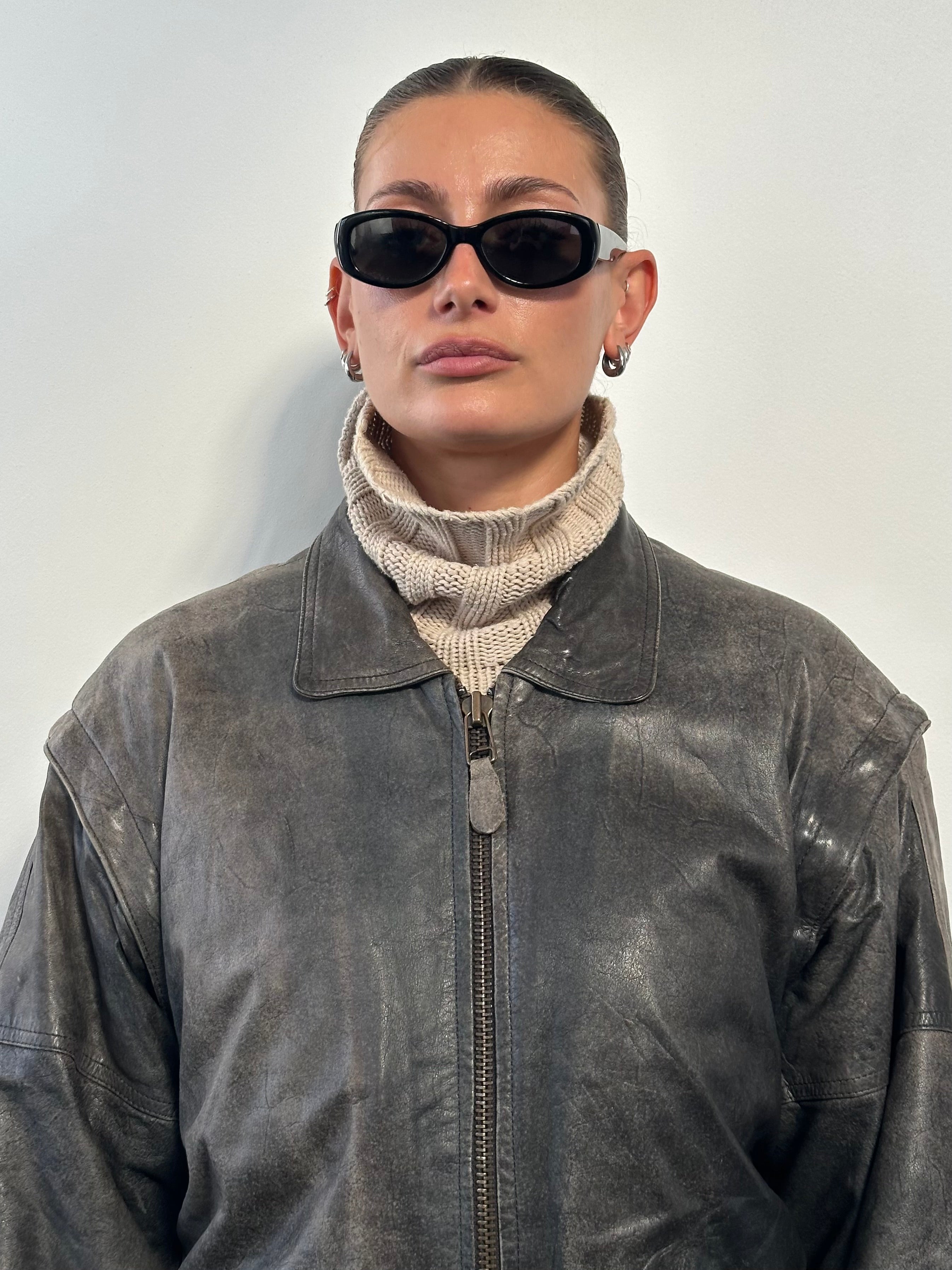 Vintage distressed leather bomber jacket in size L/XL, featuring a rugged style and classic fit.
