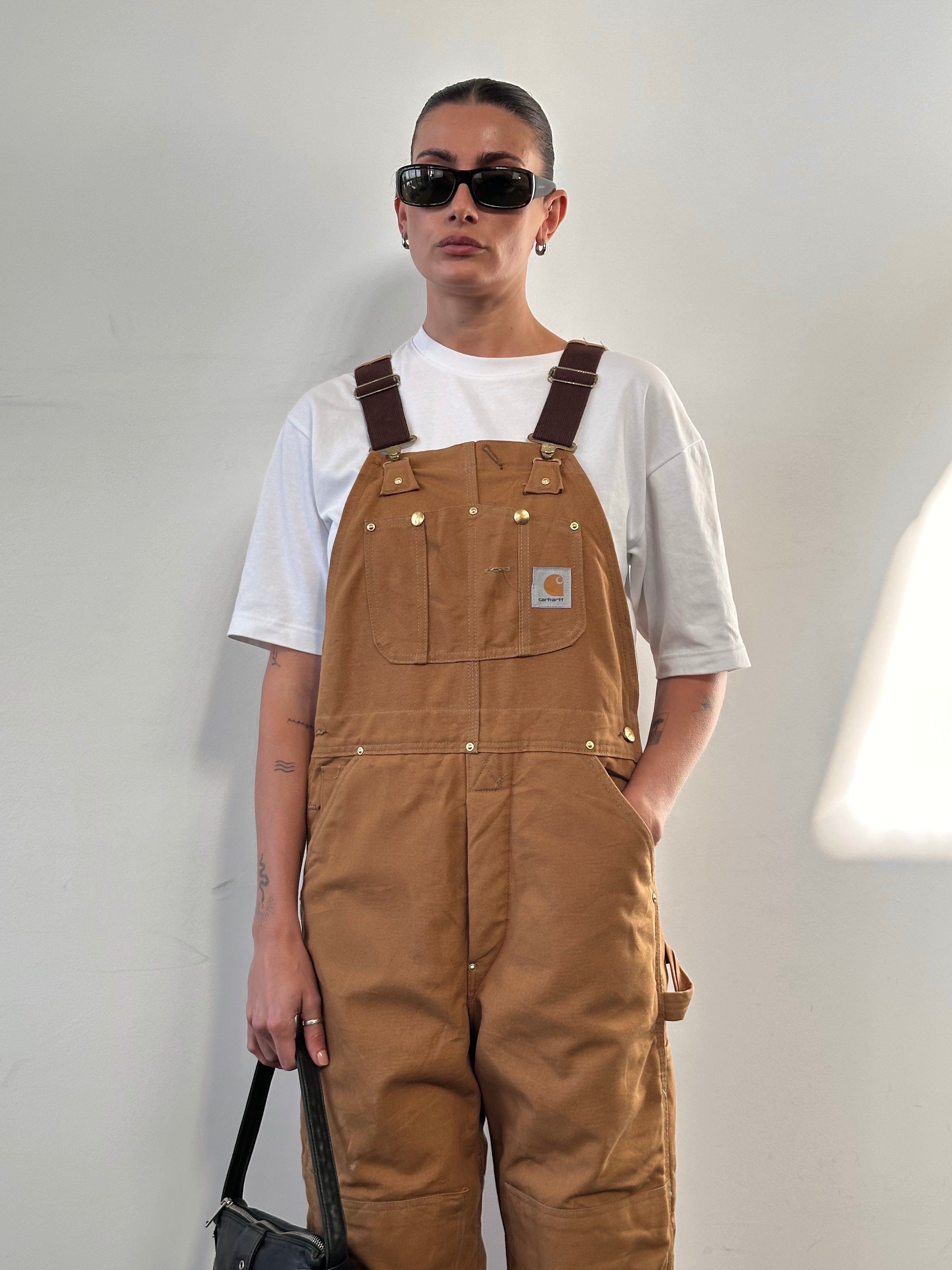 Carhartt pure cotton dungarees in size M, with durable fabric and classic design, displayed on a plain background.