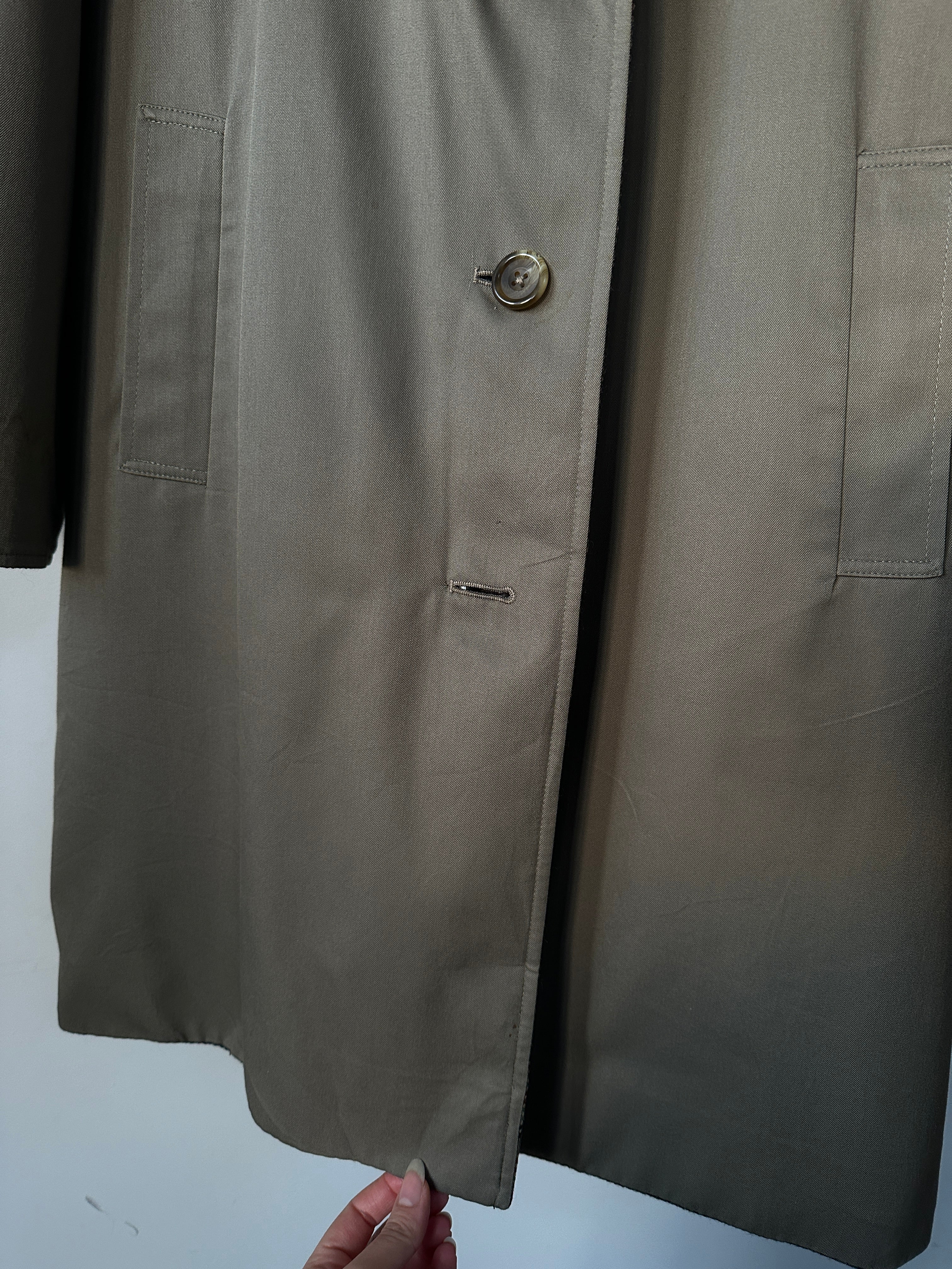 Vintage British reversible wool trench coat in size small, featuring classic design and warm, textured fabric.