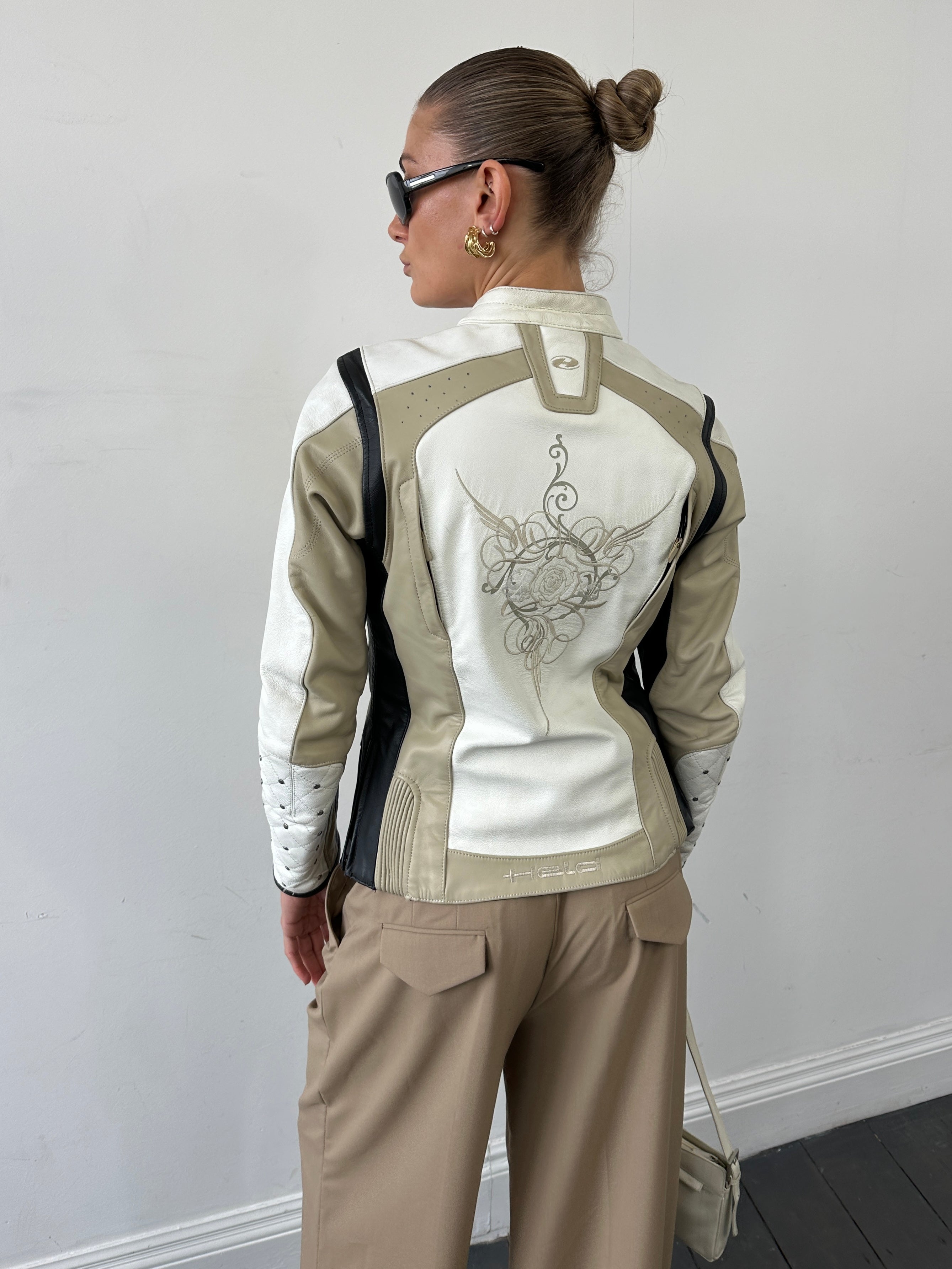 Vintage leather motorcycle jacket in size S/M featuring classic styling and durable leather construction.