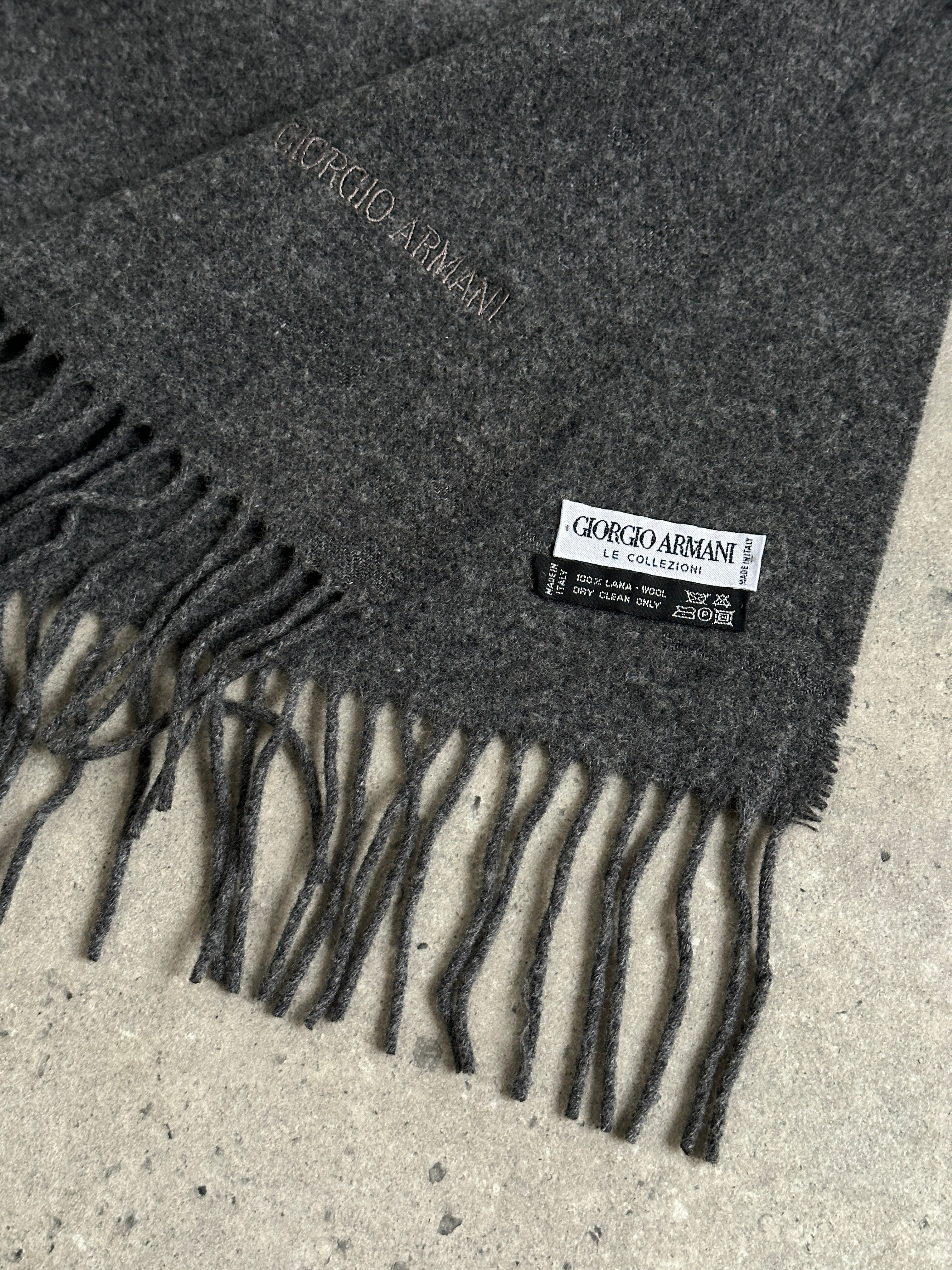 Giorgio Armani Le Collezioni pure wool logo scarf displayed flat with classic design and subtle branding visible.