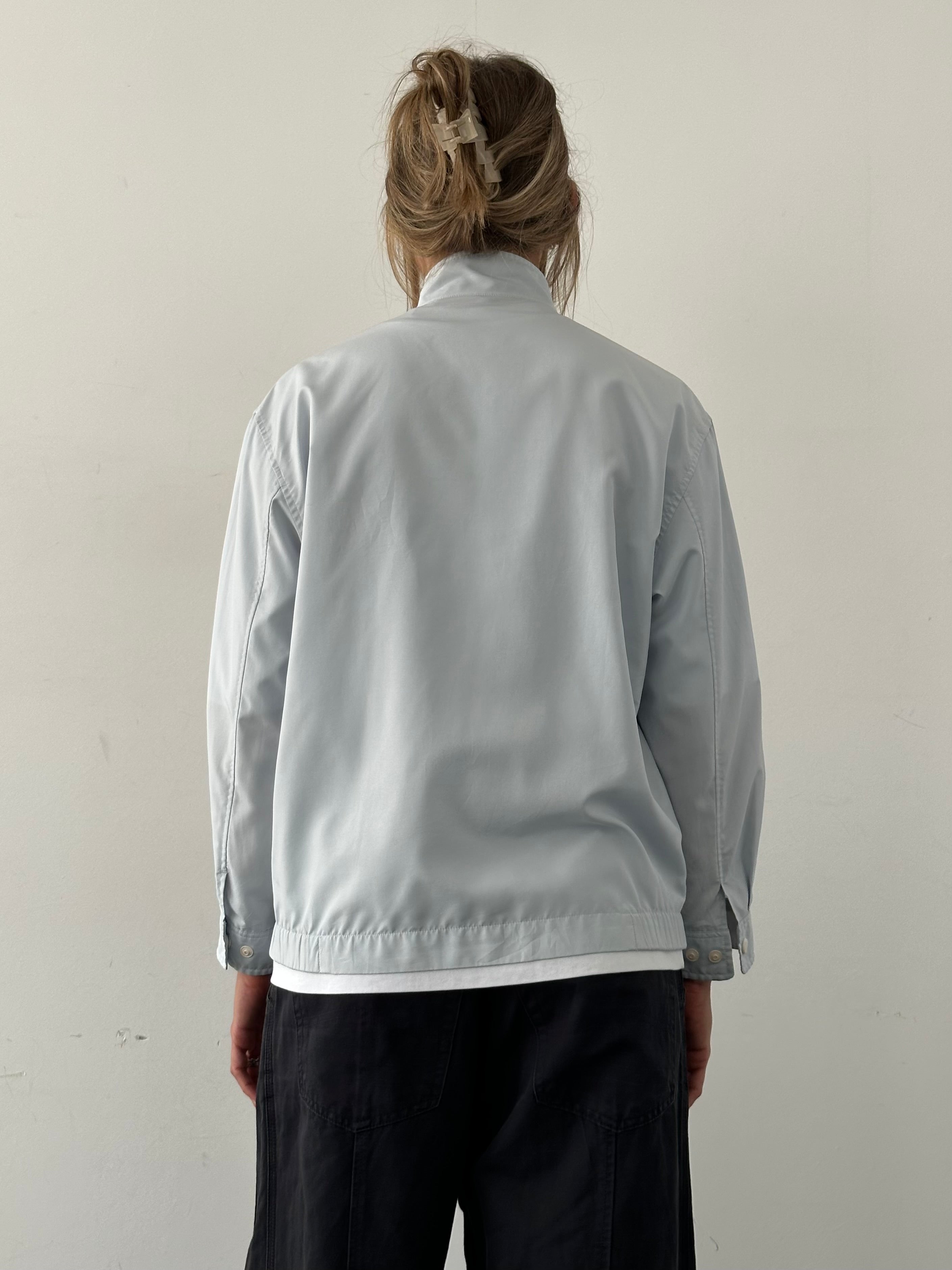 Yves Saint Laurent logo bomber jacket in size M, black with signature branding, displayed on a hanger.