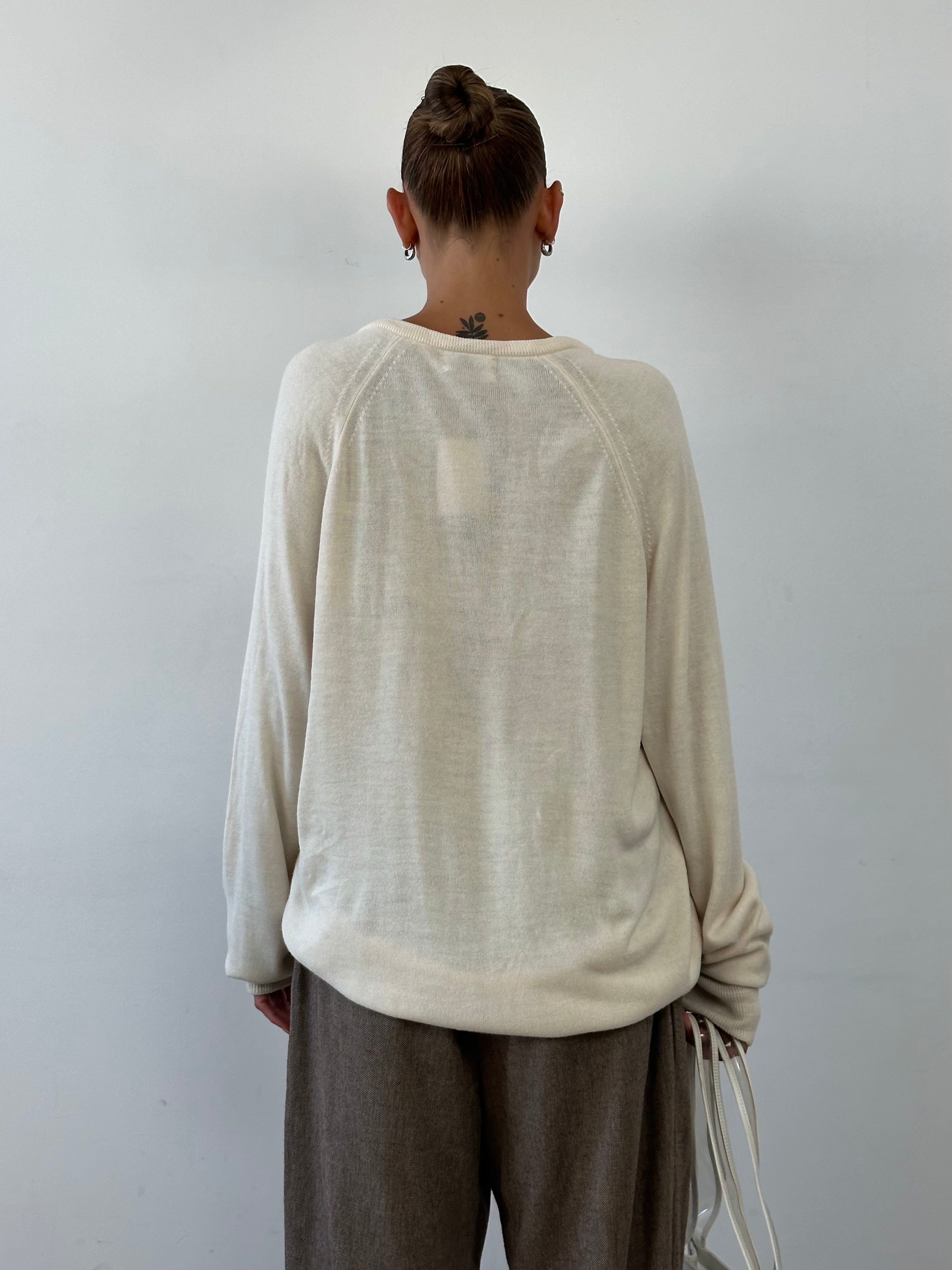 Christian Dior XL knitted jumper with V-neck and logo design, featuring a soft, textured fabric in a stylish, casual fit.