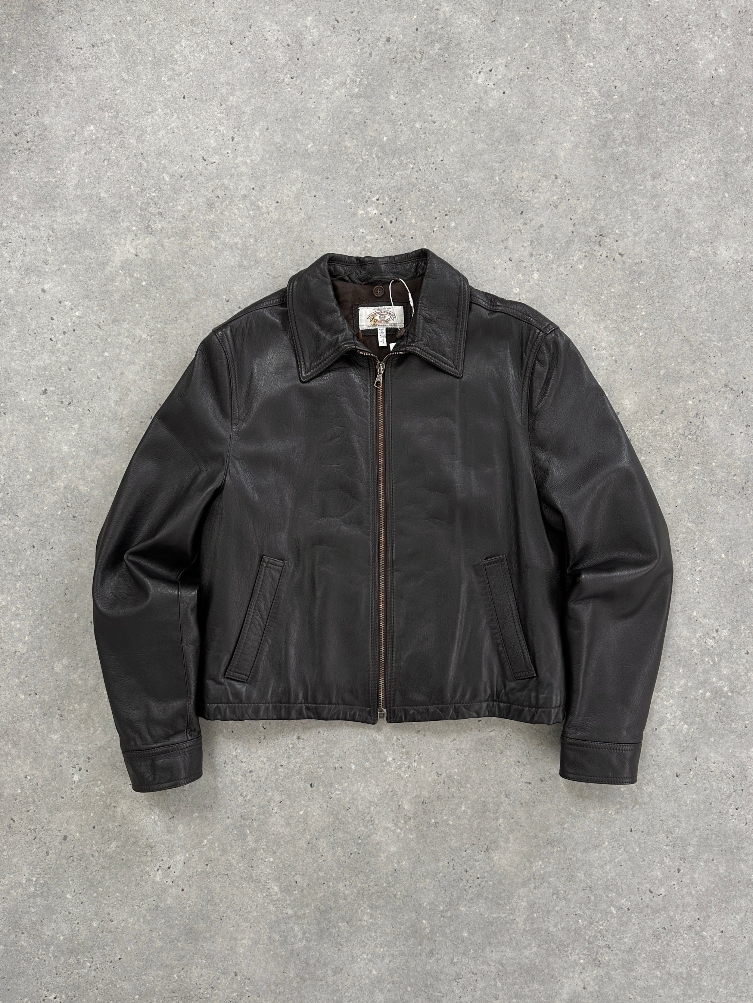 Armani Jeans leather jacket in size S/M displayed on a hanger, featuring classic black leather with a sleek, fitted design.