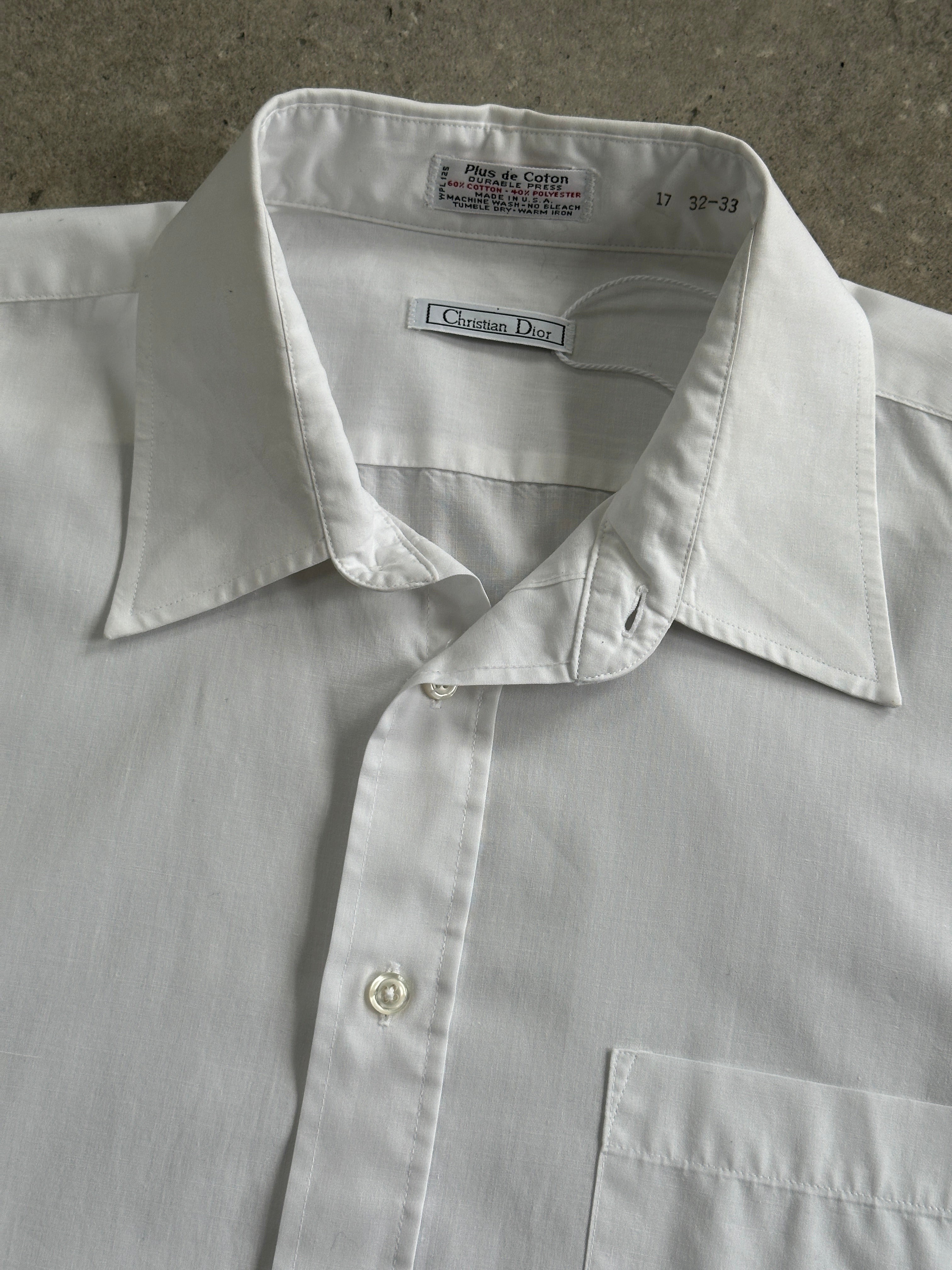 Christian Dior 1980s cotton shirt in size M/L, featuring classic design and lightweight fabric, displayed on a hanger.