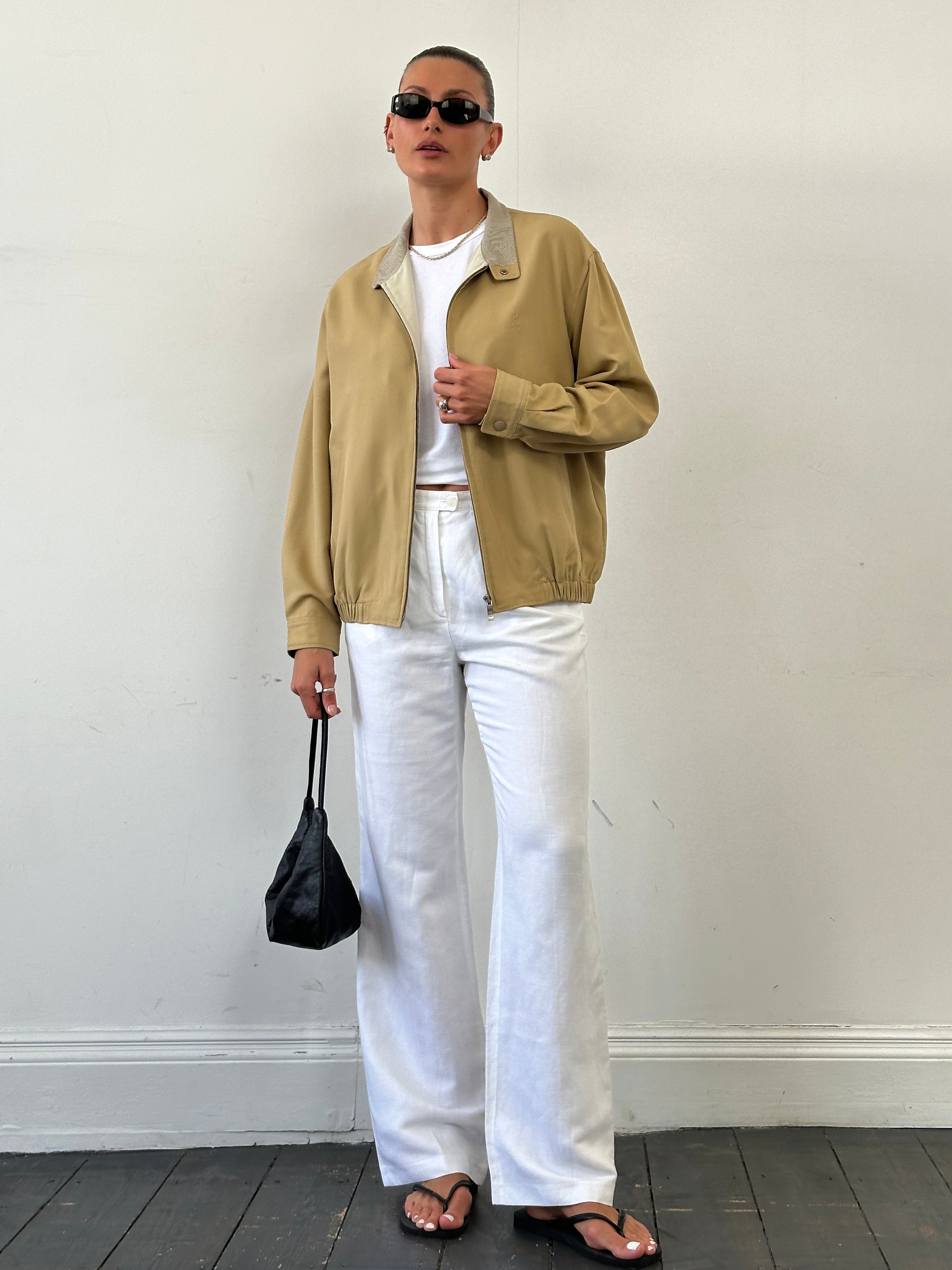Yves Saint Laurent logo bomber jacket in size M/L, featuring a sleek design with the iconic YSL logo on the front.