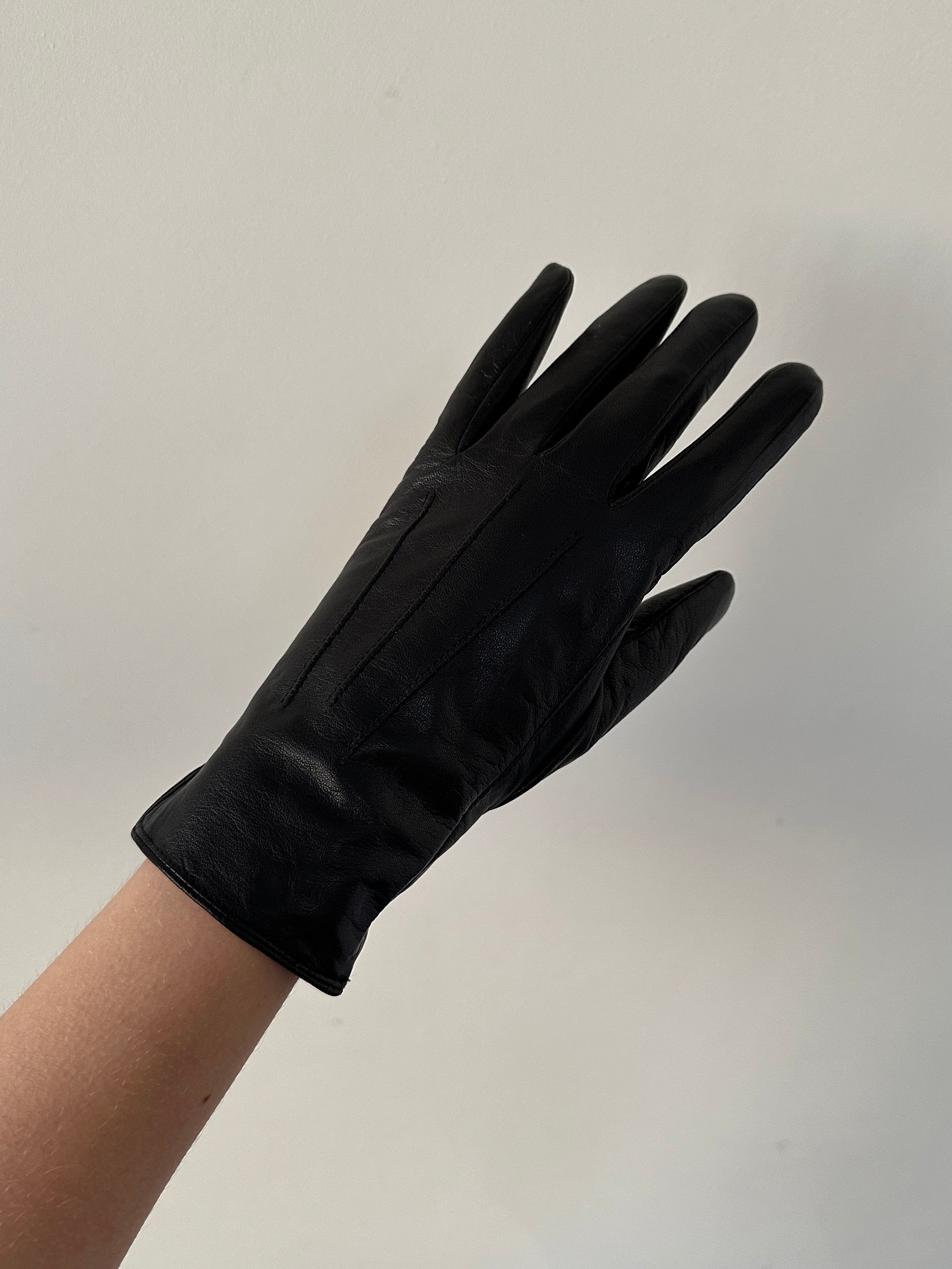 Vintage leather gloves displayed flat, showing the classic design and rich brown color of the Vintage brand gloves.