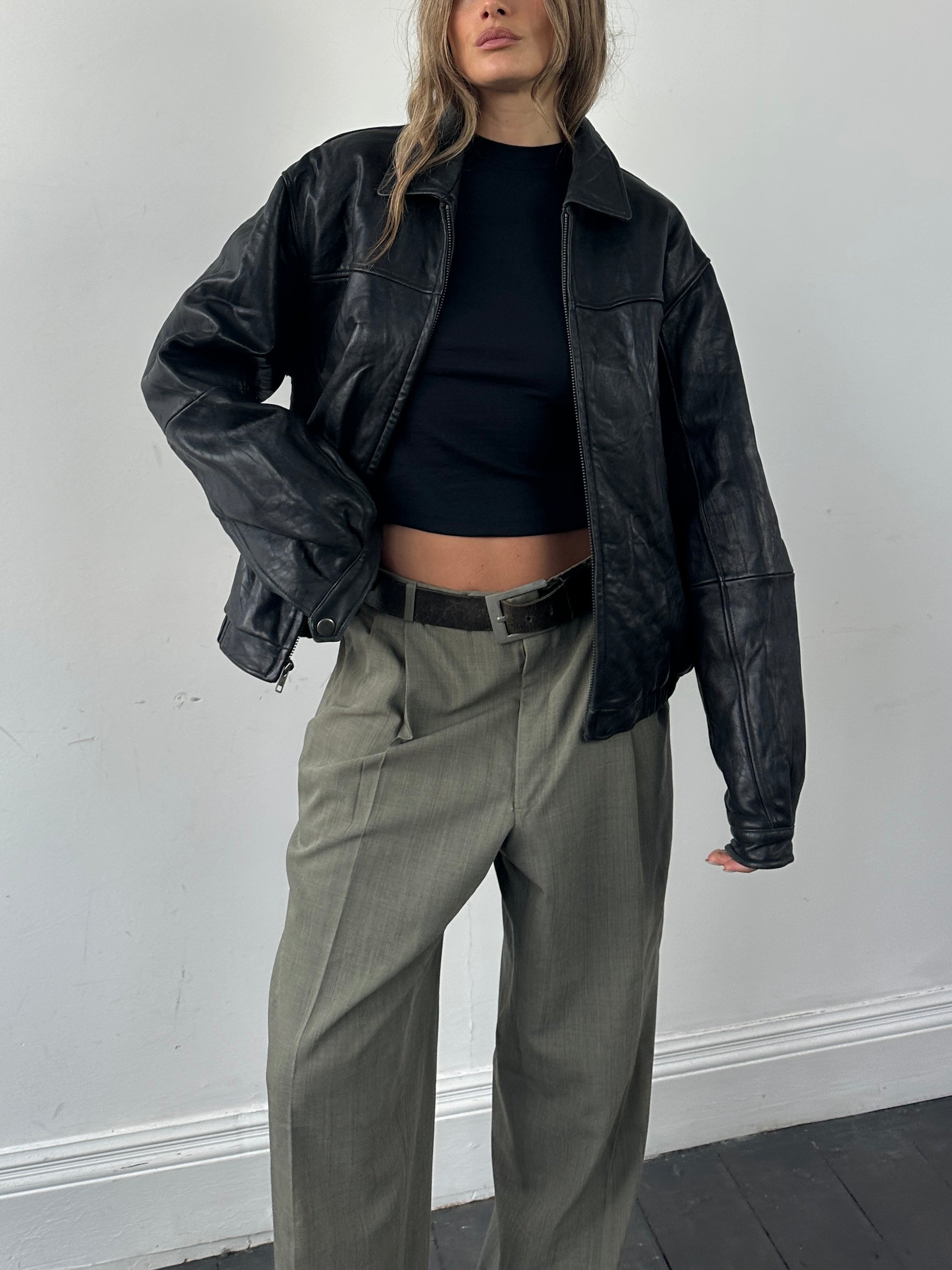 Vintage soft leather bomber jacket in classic minimal style, shown in size M with sleek design and smooth texture.