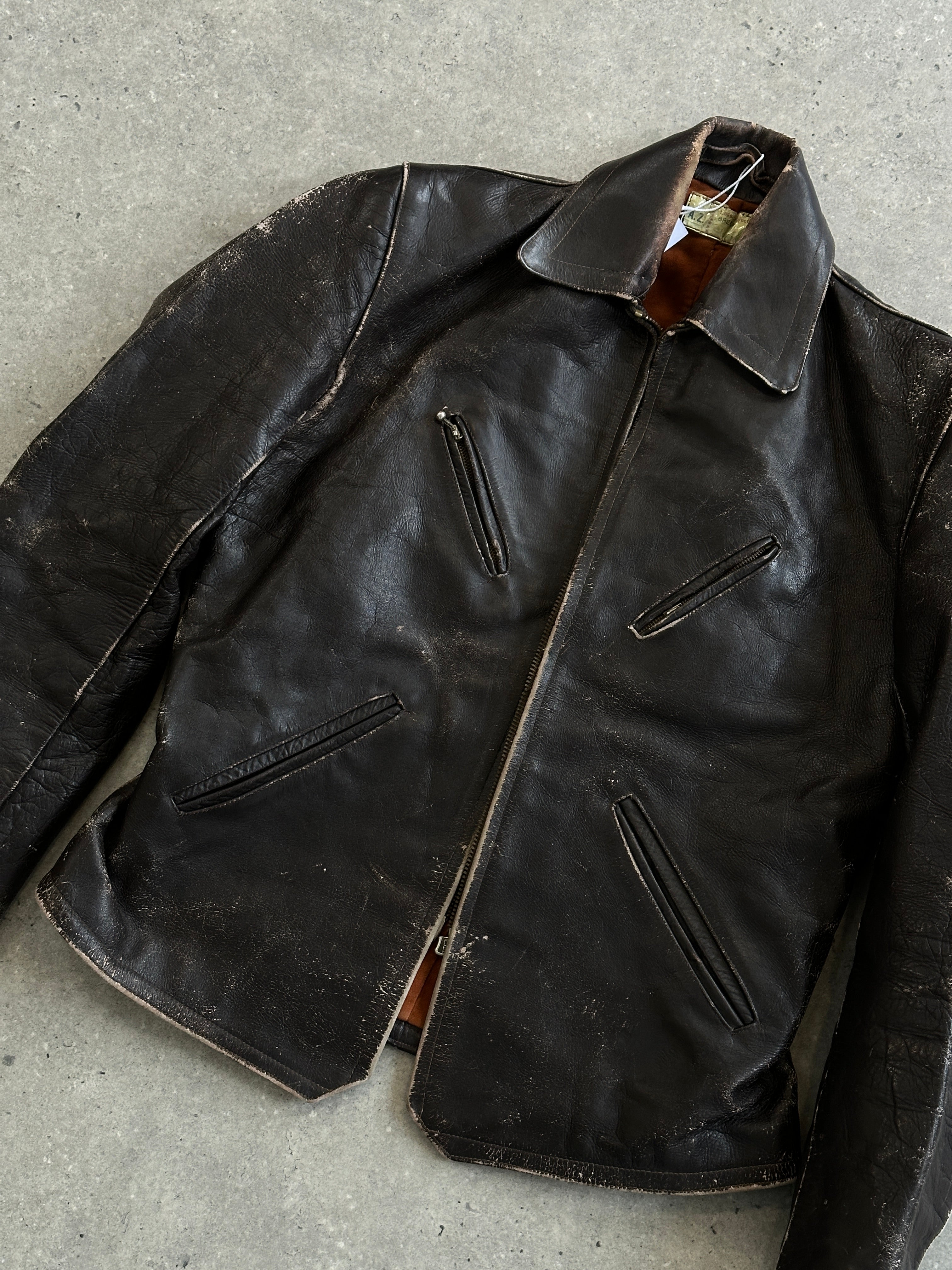 Vintage distressed structured leather jacket in size S/M featuring rugged design and classic fit.