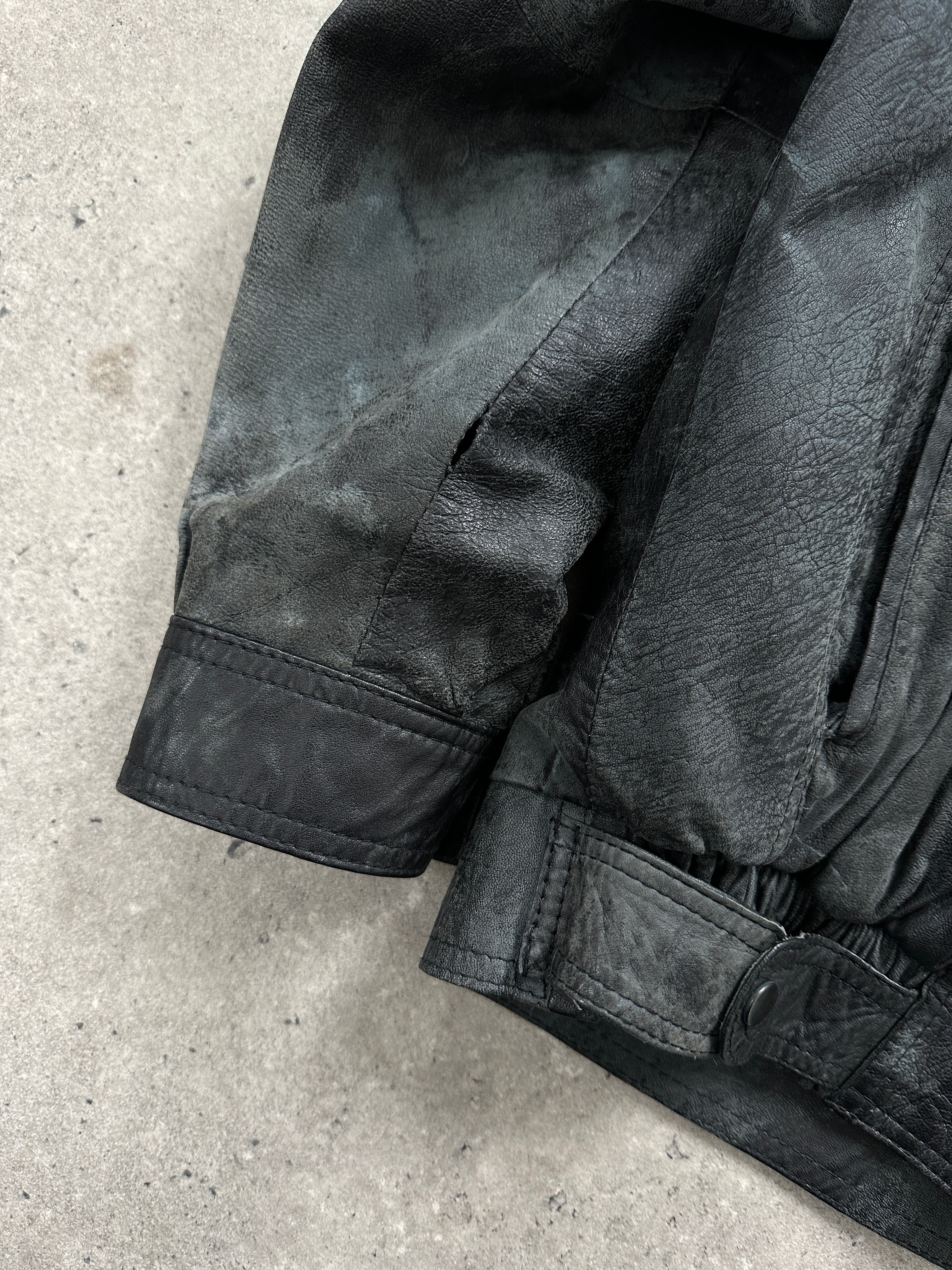 Vintage distressed marbled leather jacket, size M, showcasing rugged texture and unique marbling details.