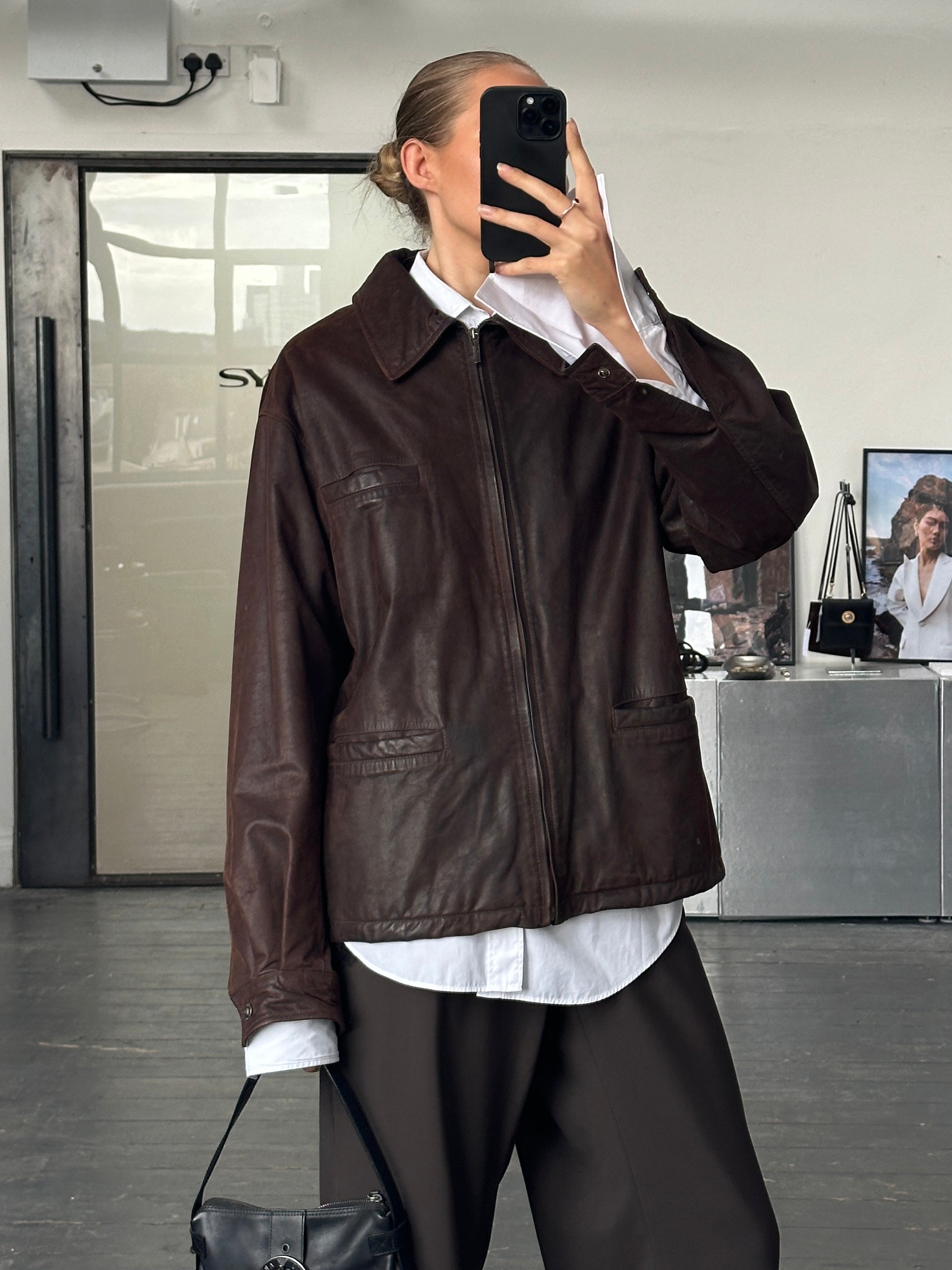 Versace Jeans Couture 1990s boxy leather jacket in black with silver hardware and cropped design, front view with open collar.