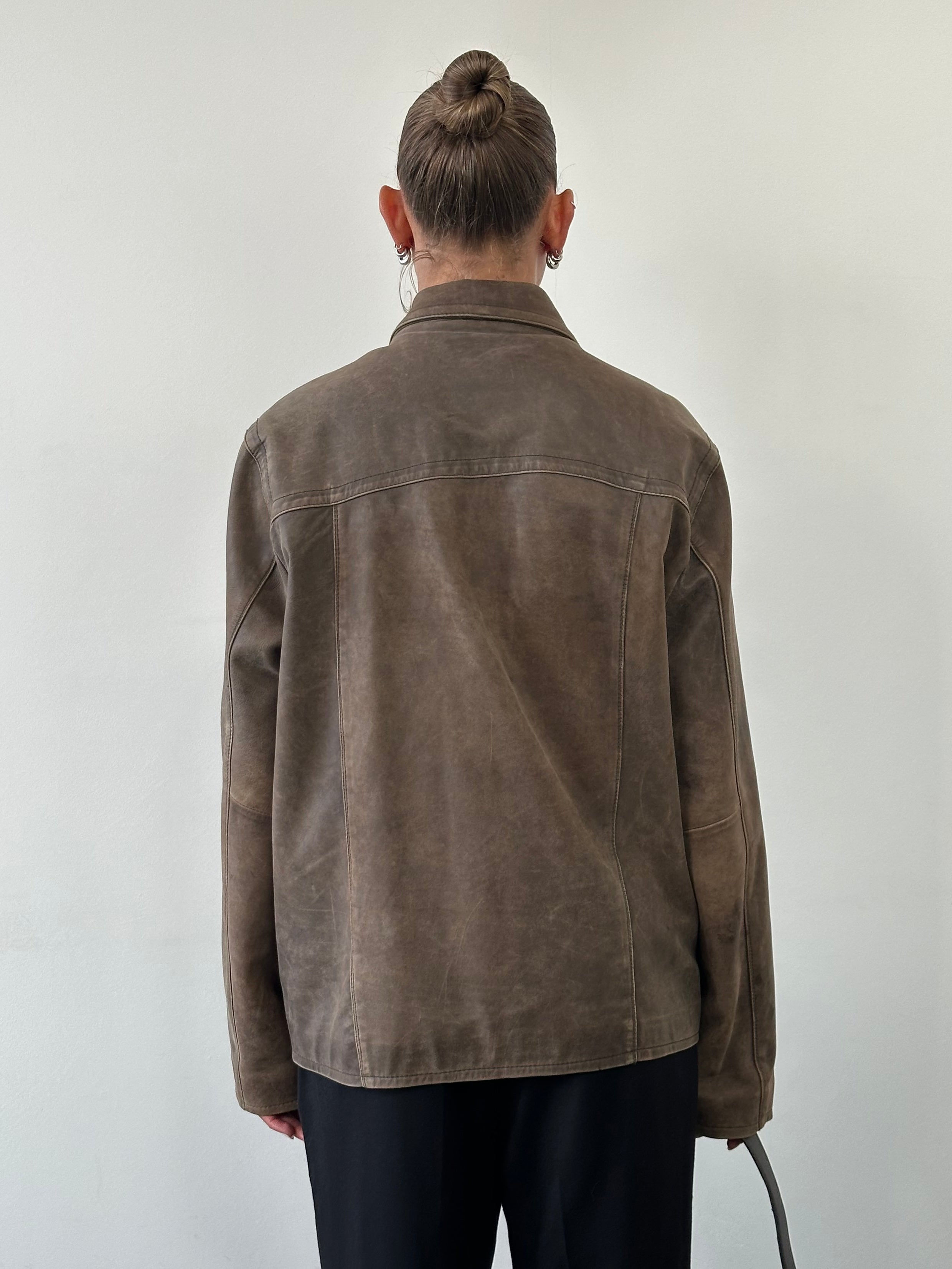 Vintage distressed leather jacket in size L, featuring rugged texture and classic style, shown on a hanger.