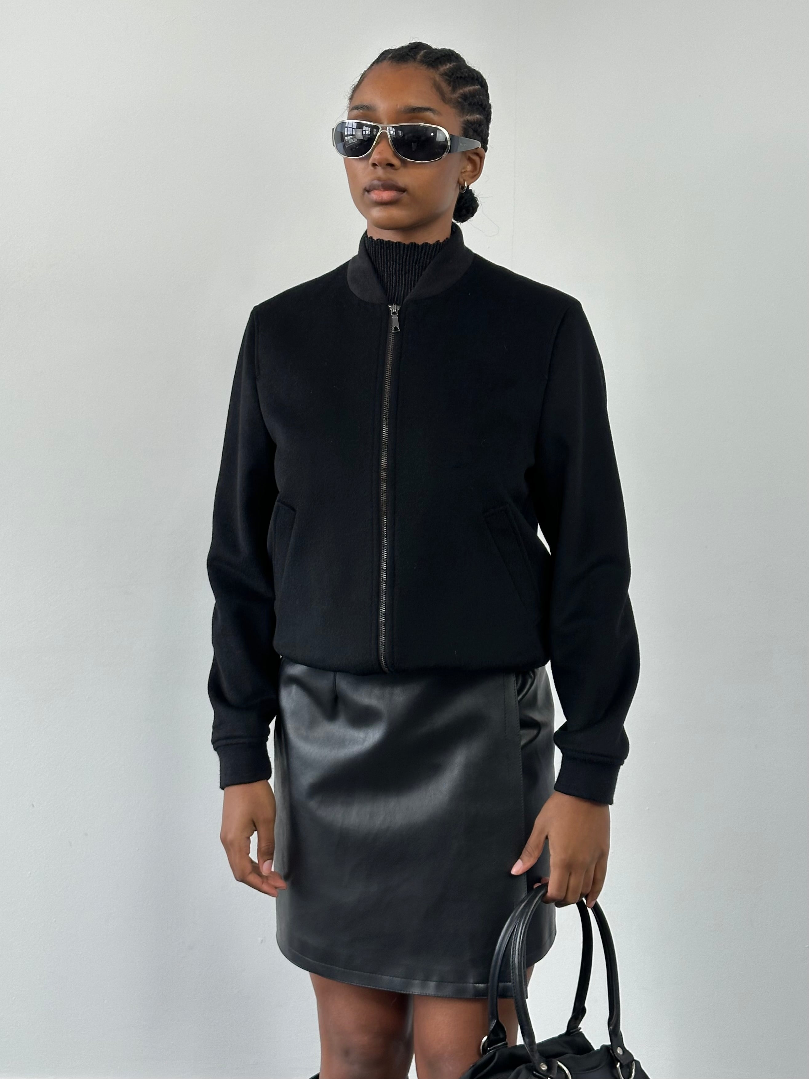 Jaeger minimal pure wool bomber jacket in size S, navy blue, with ribbed cuffs and collar, displayed on a hanger.