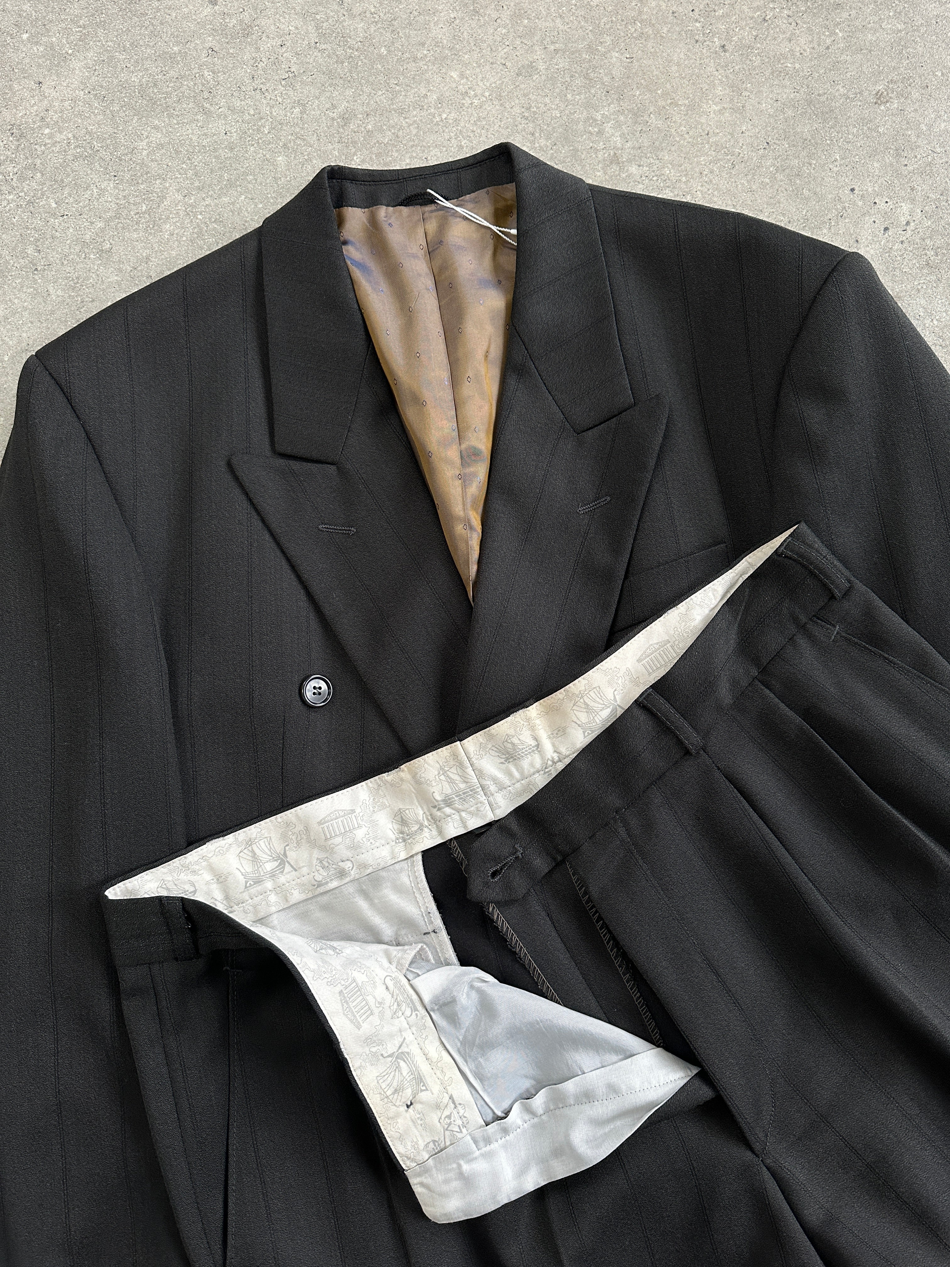 Vintage wool pinstripe double-breasted suit in size 44R/W34, tailored fit with classic lapels and structured shoulders.