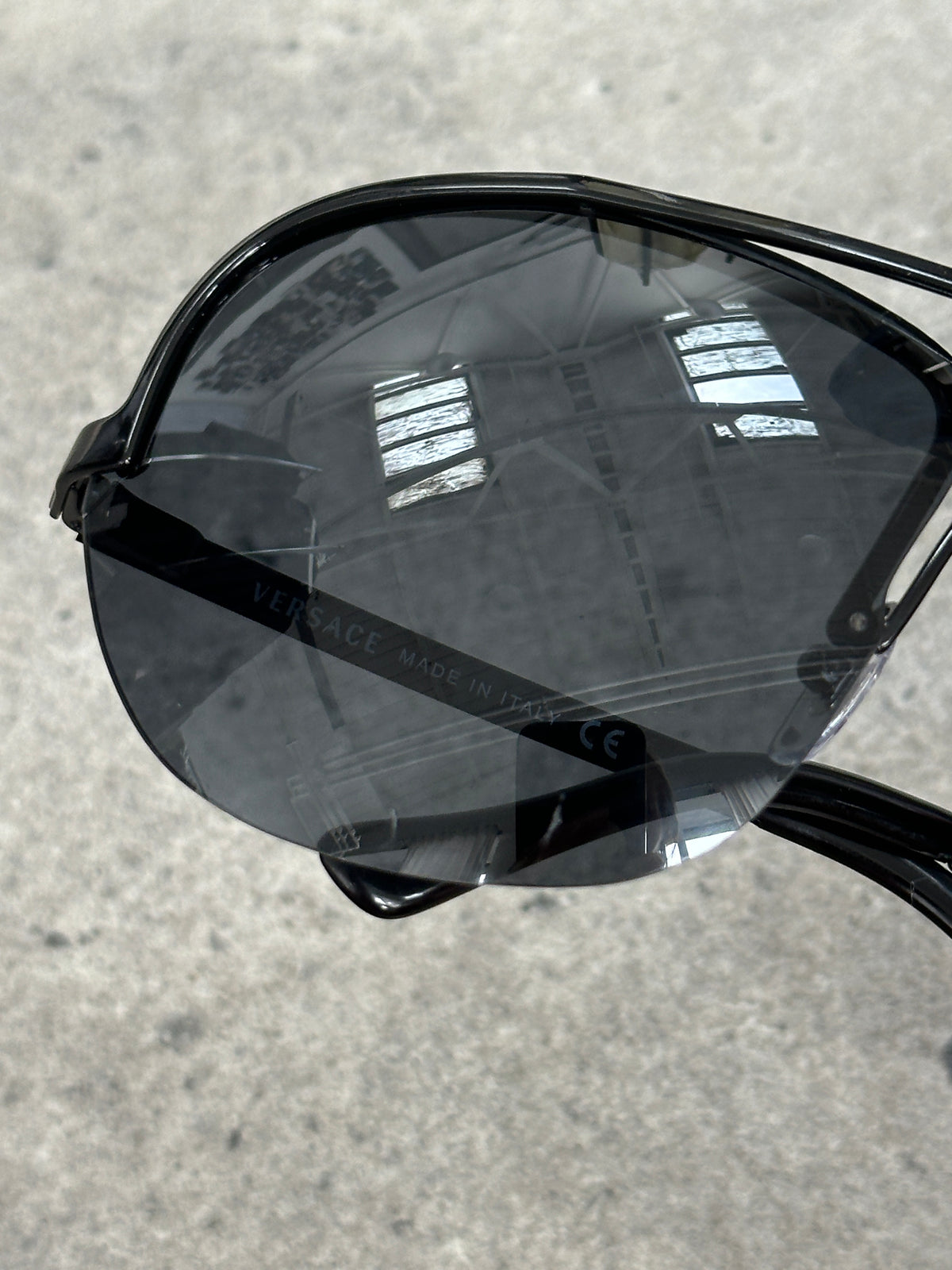 Versace 2000s Shield Aviator Logo Sunglasses with bold black frames and signature Versace emblem on the arms.