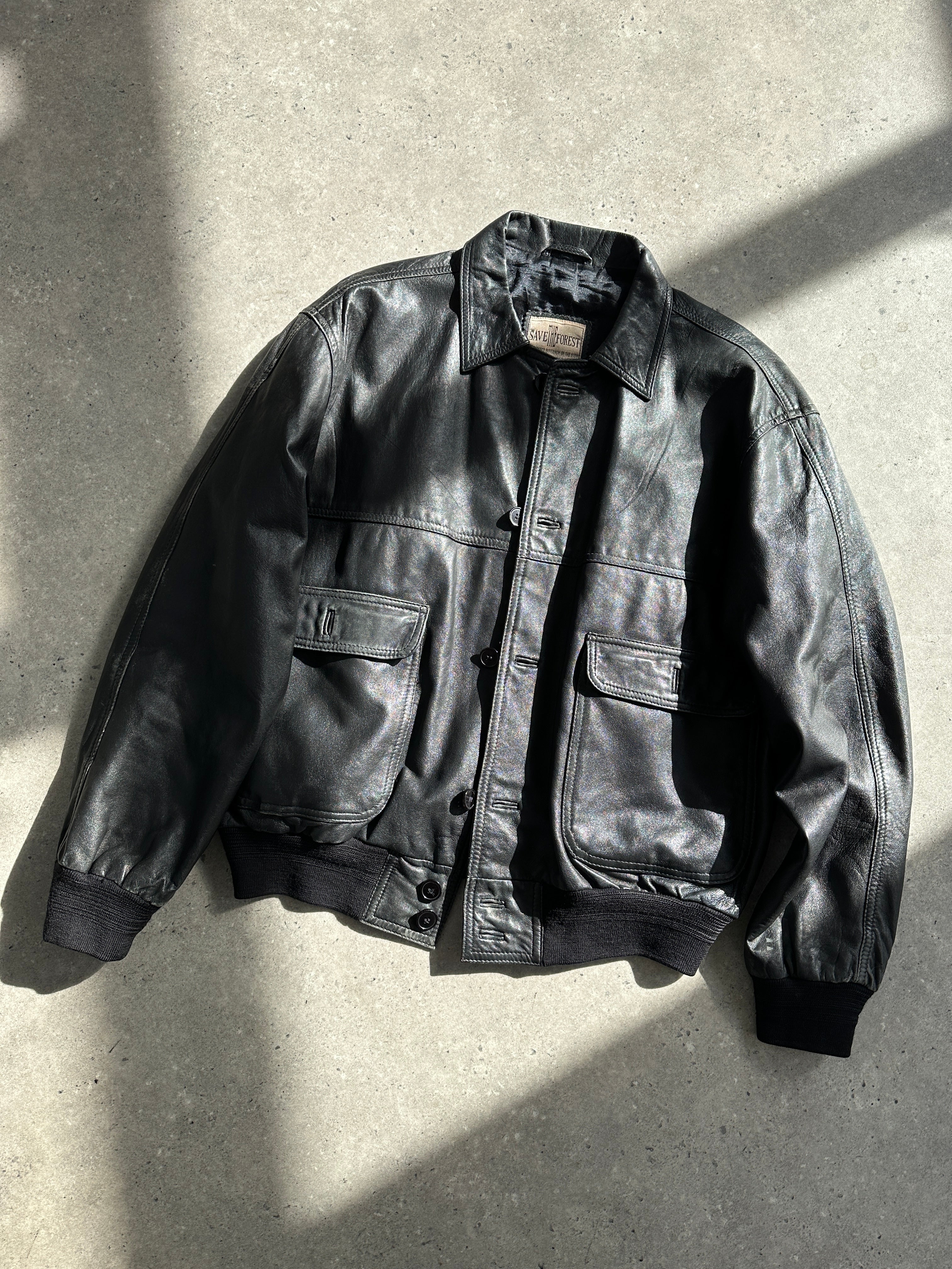 Vintage leather bomber jacket in size M featuring classic design, visible collar, and front zipper on a neutral background.