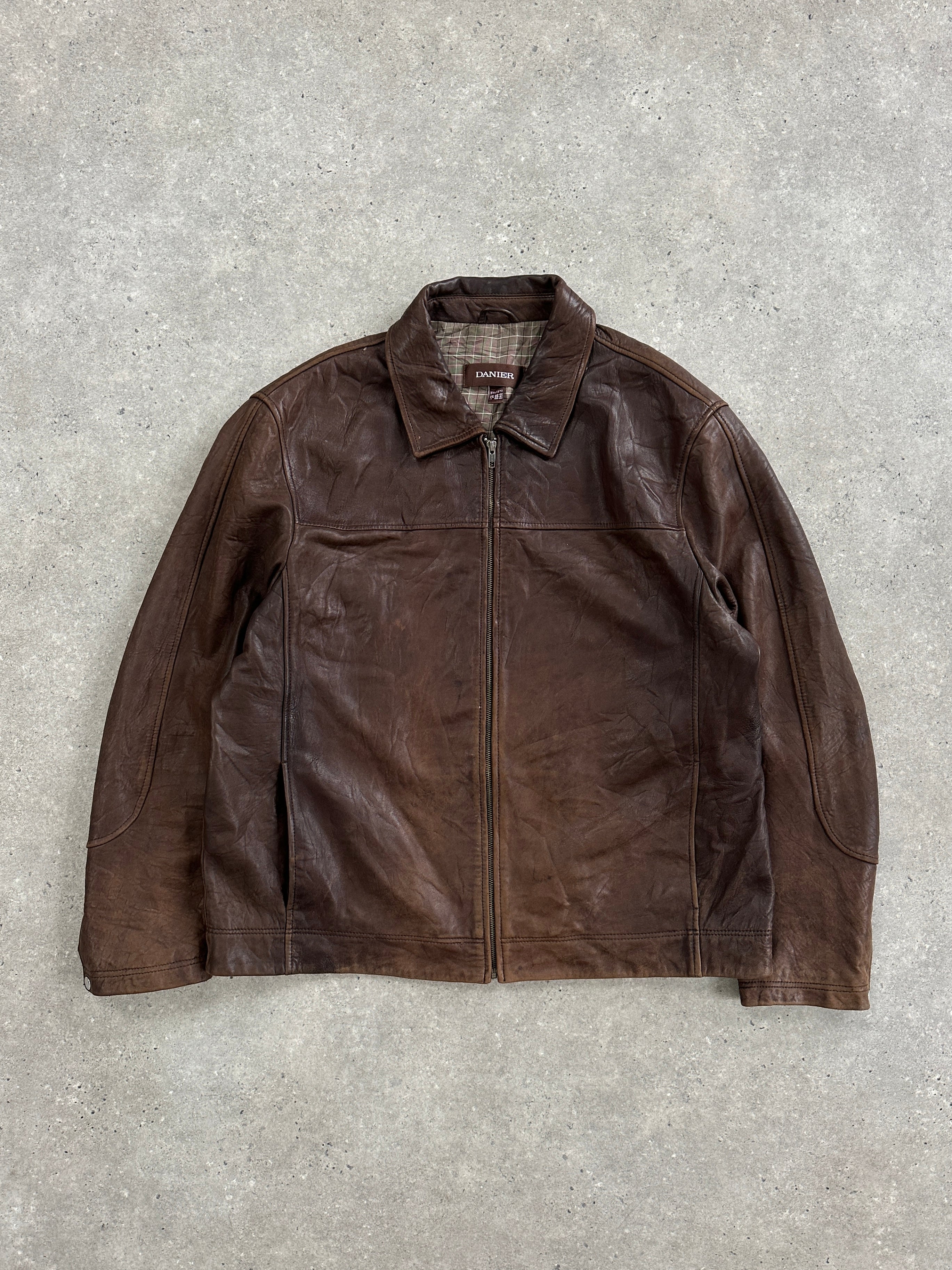 Vintage 1990s distressed leather jacket in XXL size, showcasing rugged texture and classic style.