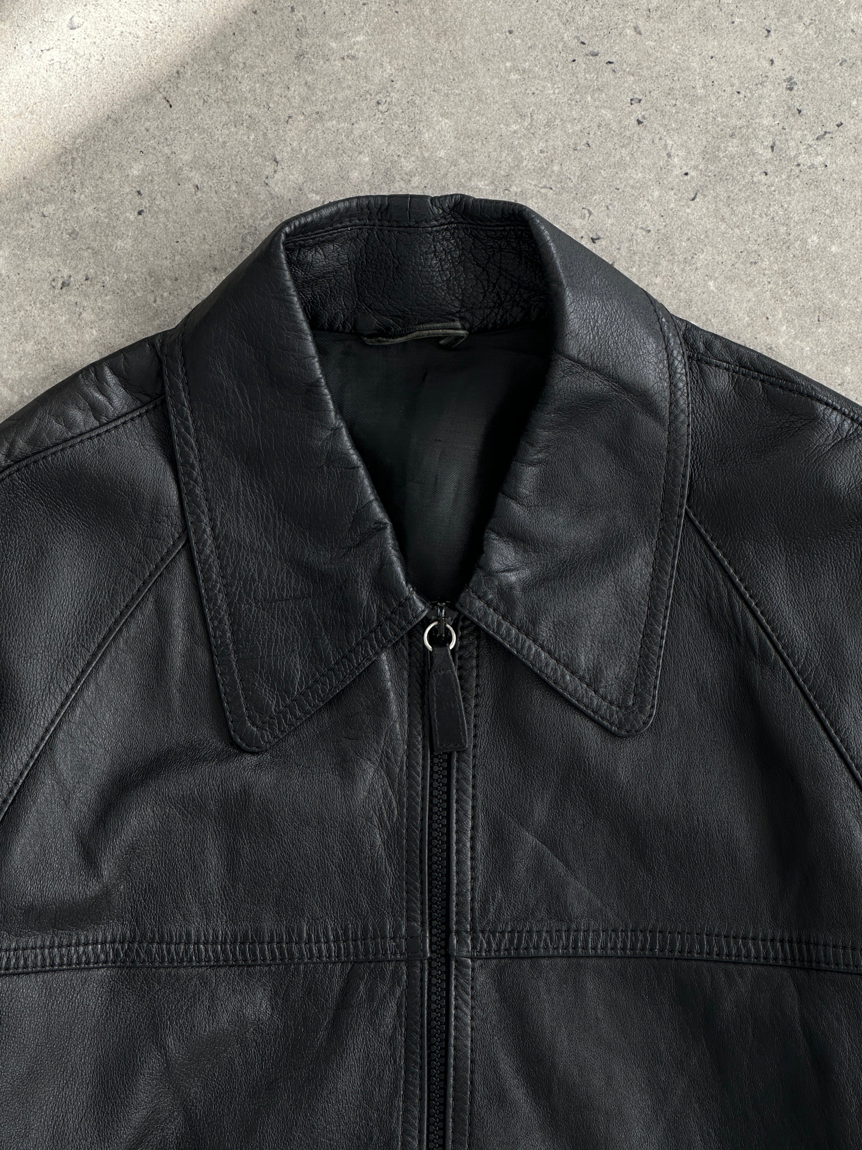 Vintage leather bomber jacket with dagger collar, size large, featuring classic vintage style and detailed stitching.