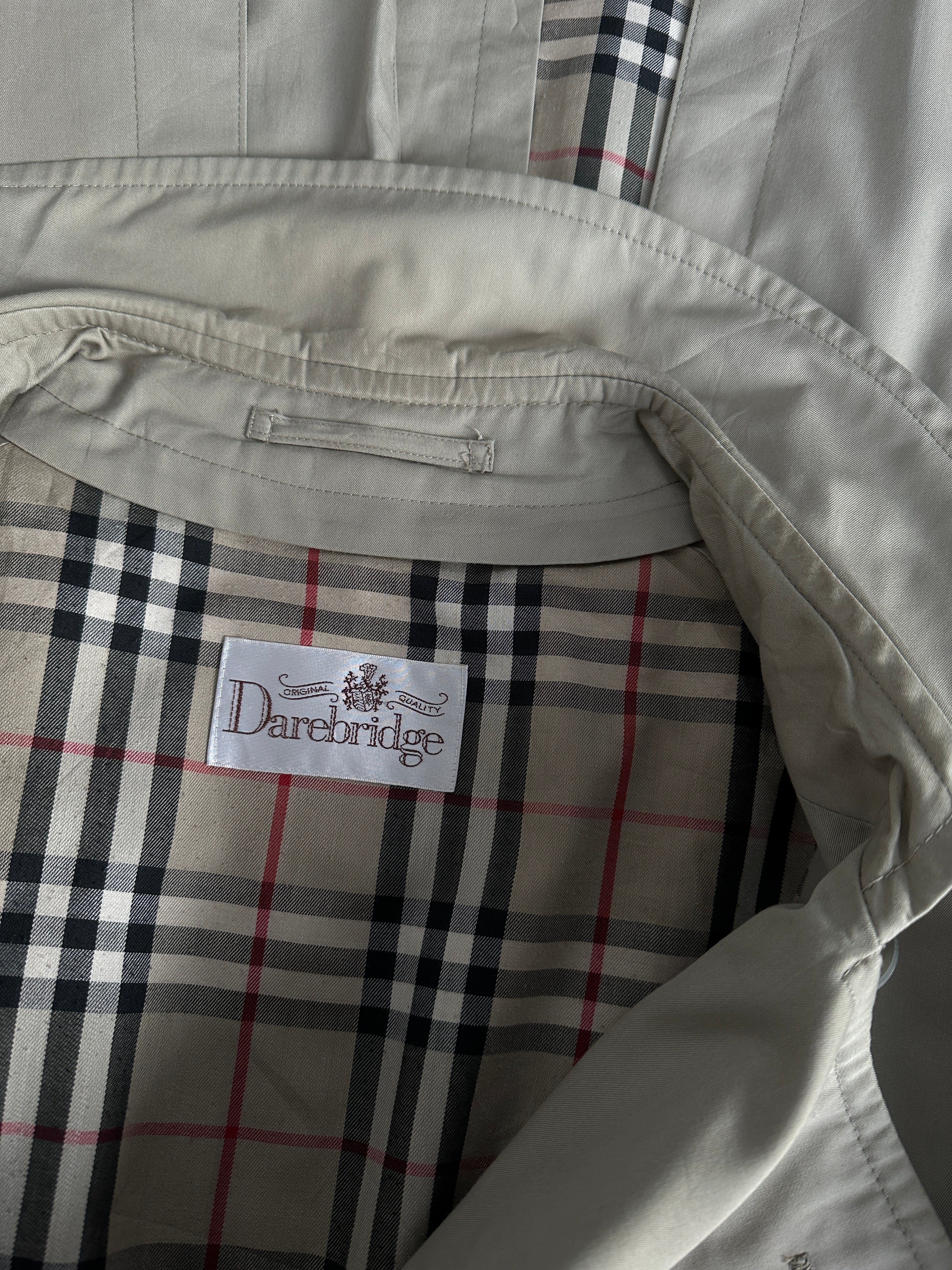Vintage double-breasted trench coat in XXL size, classic style with belted waist and button details, displayed on a hanger.