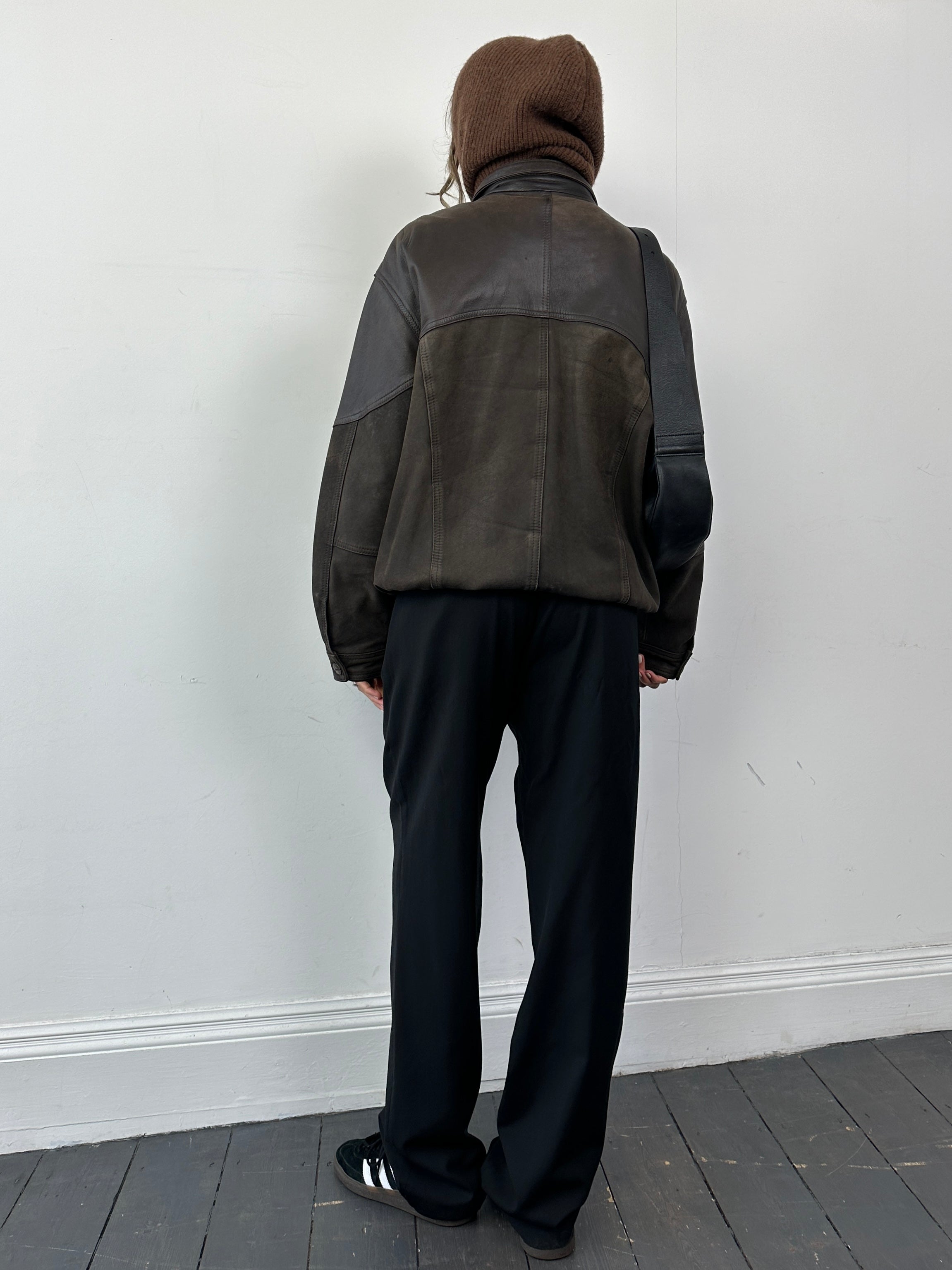 Vintage aged leather bomber jacket in size large, featuring distressed leather and classic design details.