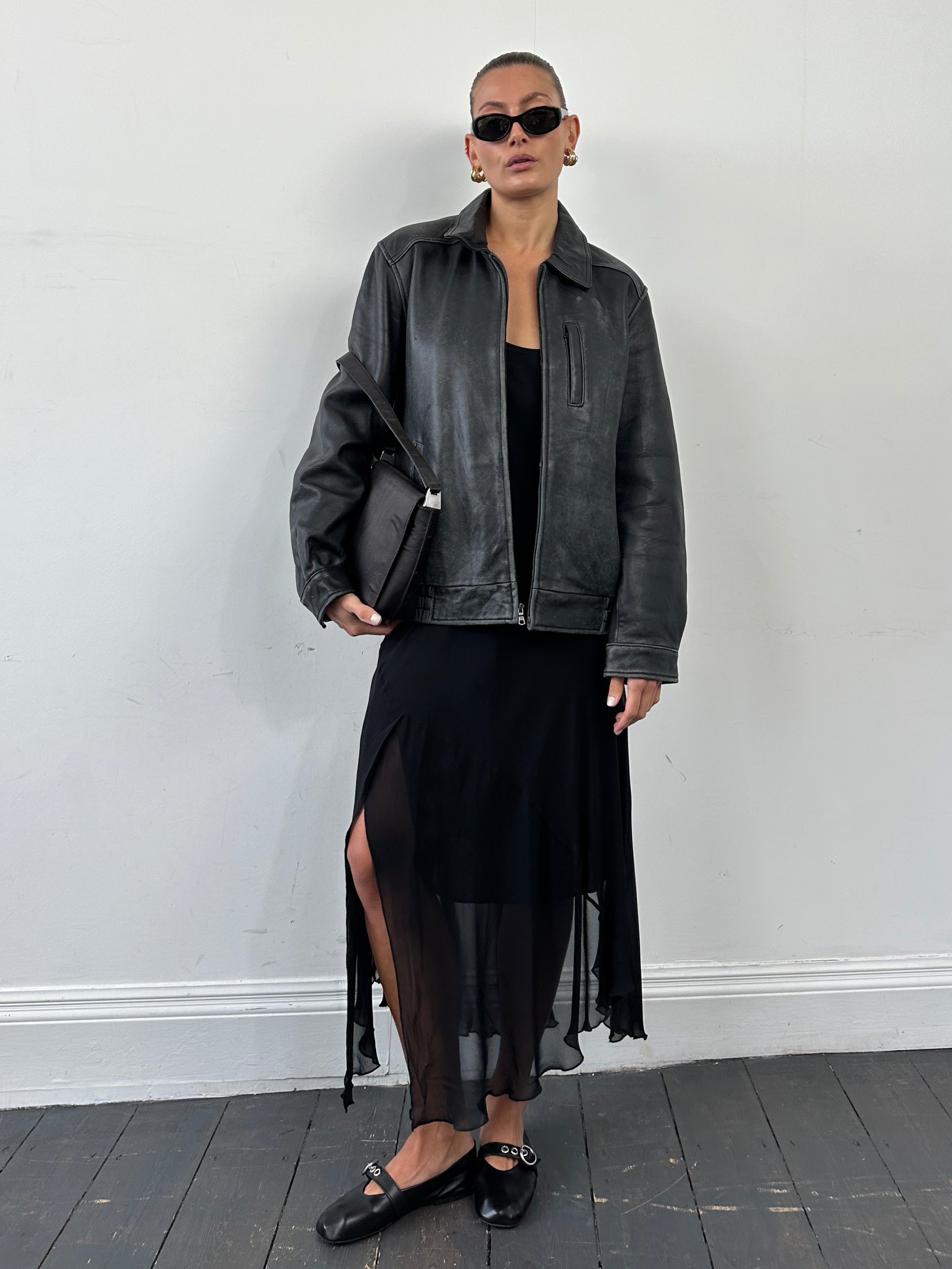 Tommy Hilfiger distressed leather bomber jacket in size M, with a rugged style and classic design, shown on a hanger.
