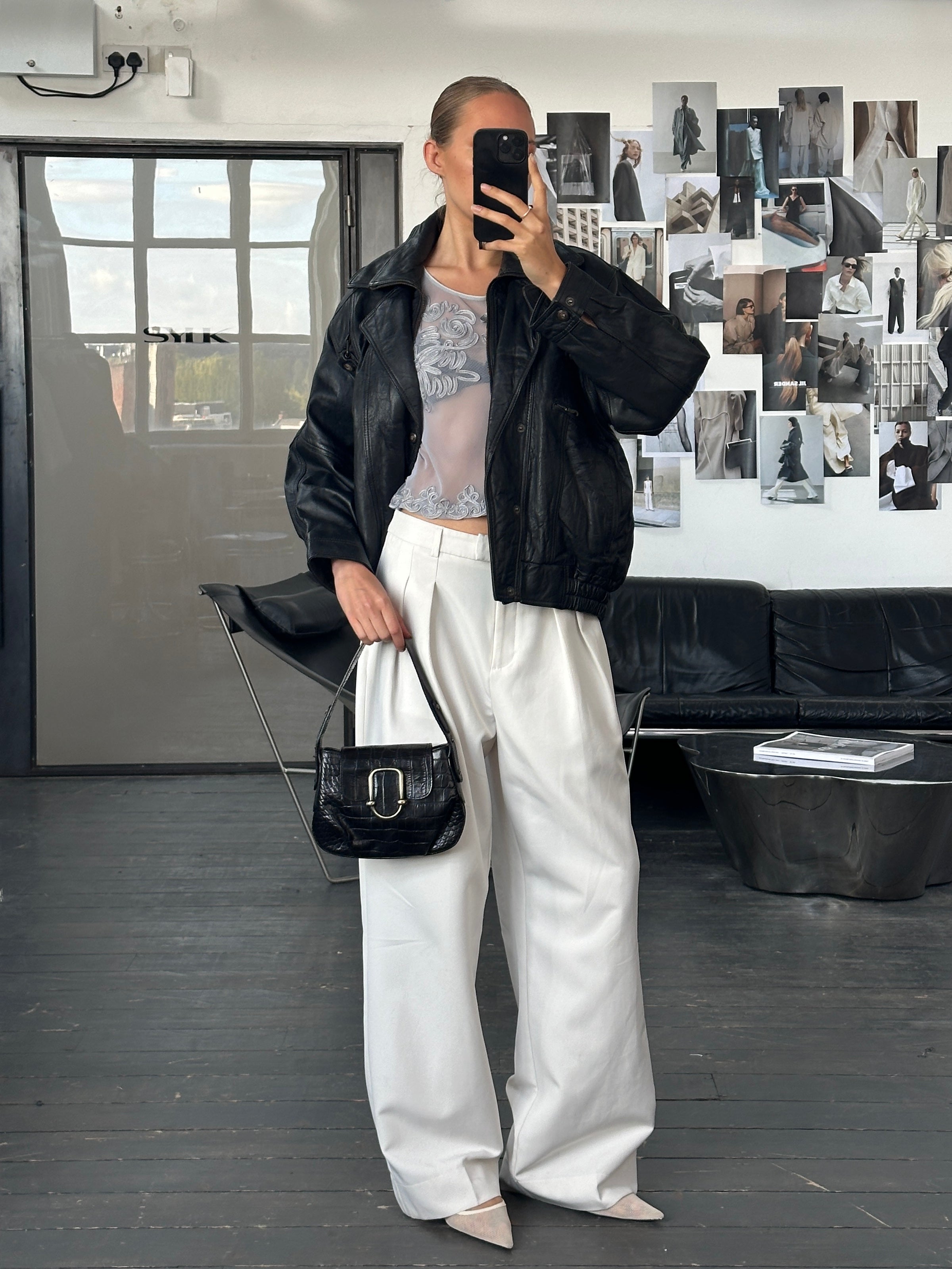 Vintage 1990s high neck leather bomber jacket, size M, featuring classic black leather and a sleek, retro style.