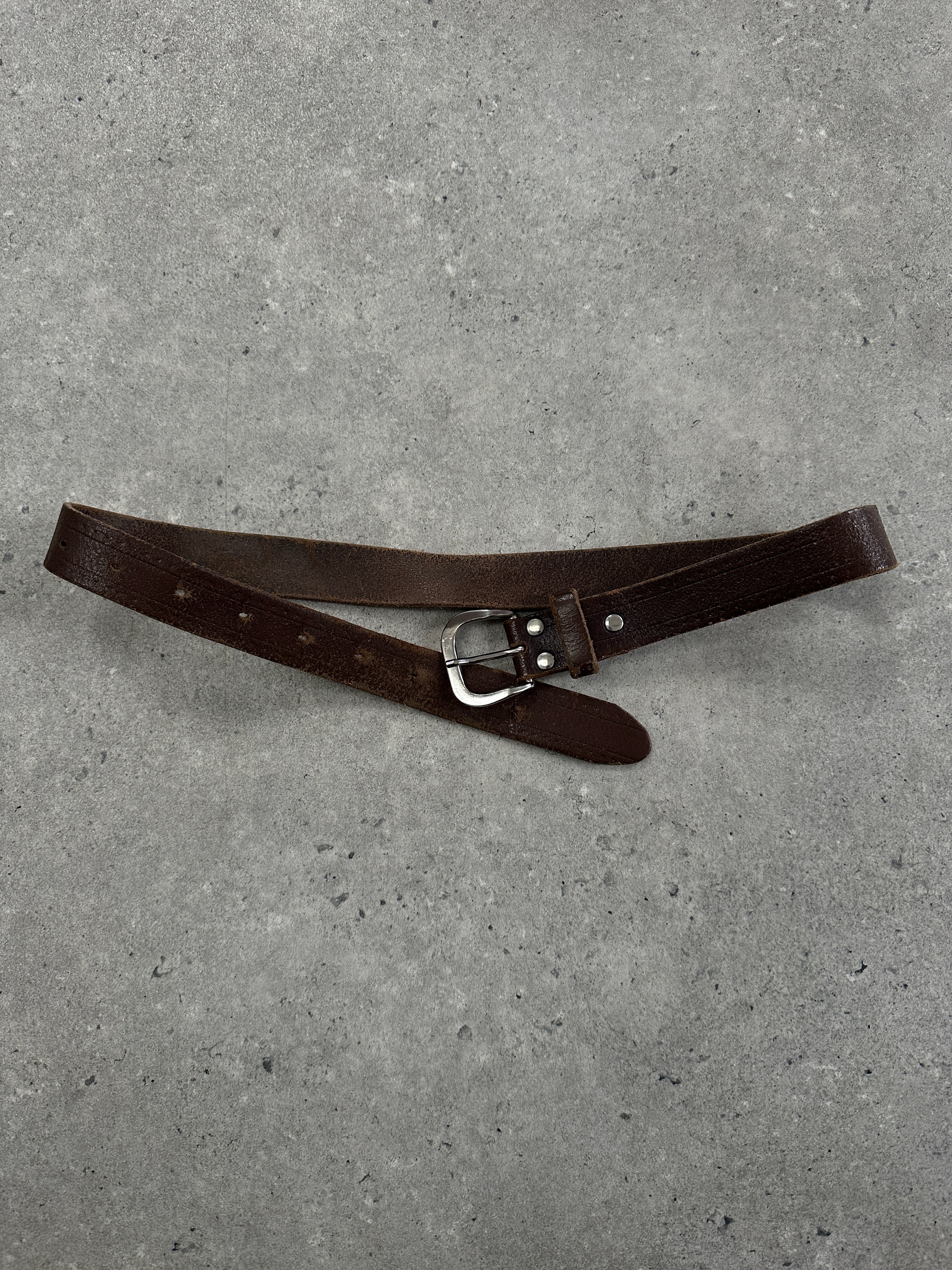 Vintage 1990s distressed slim leather belt with a buckle, 22-29 inches length, from the Vintage brand.