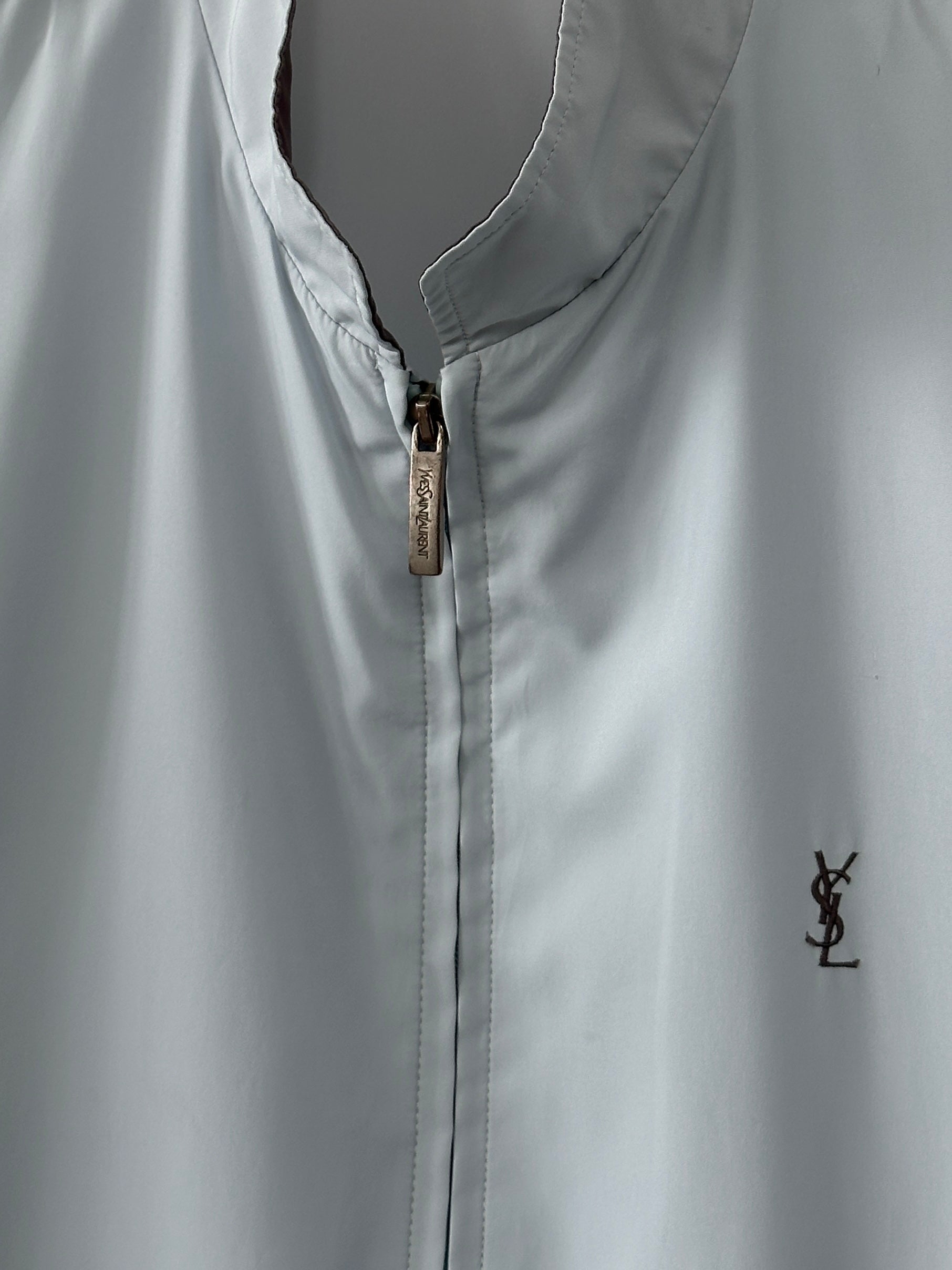 Yves Saint Laurent logo bomber jacket in size M, black with signature branding and ribbed cuffs, front view showing stylish design.