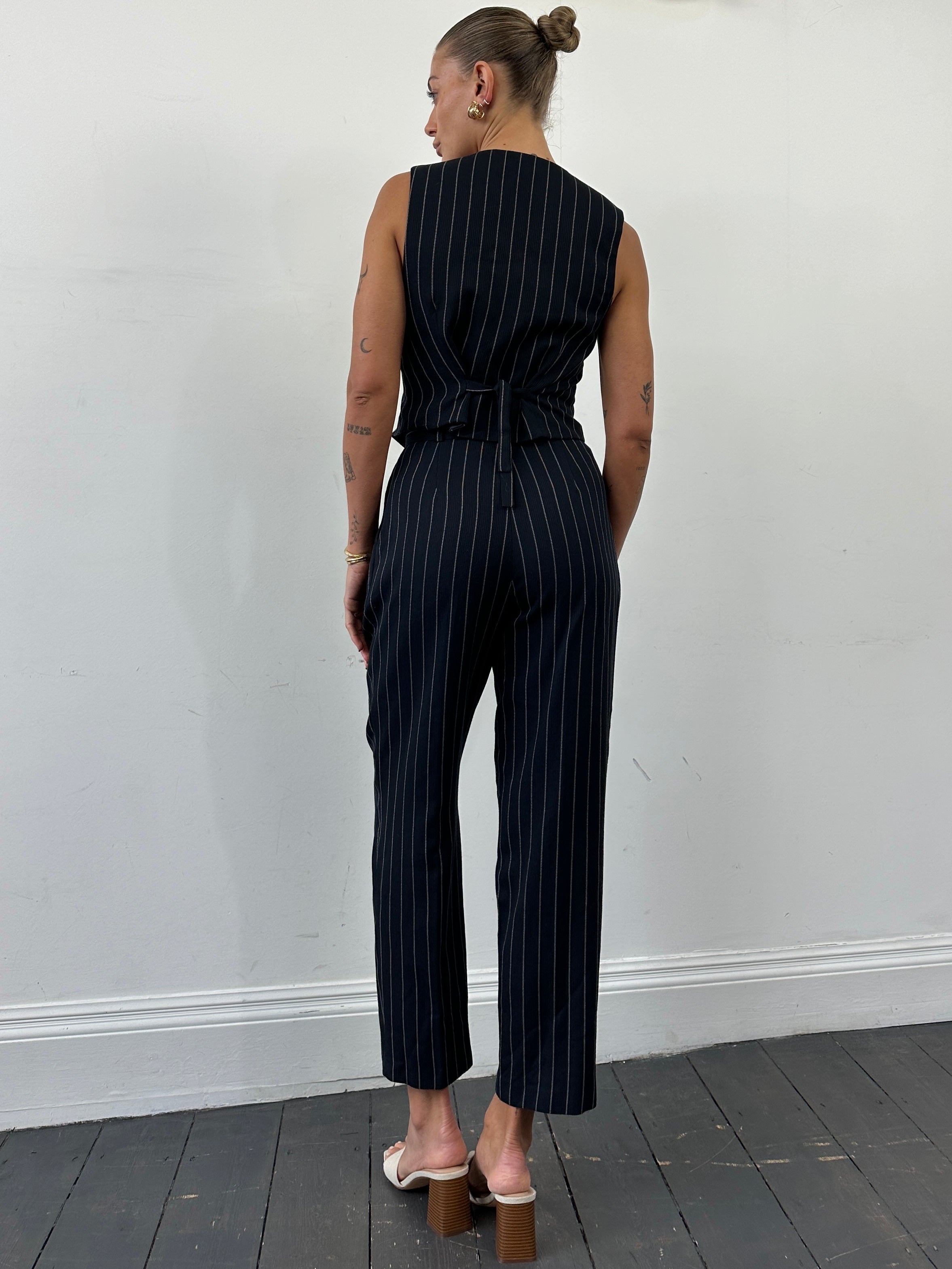 Vintage British vintage pinstripe two-piece waistcoat and trousers set, size M, classic tailored men's suit with pinstripe pattern.