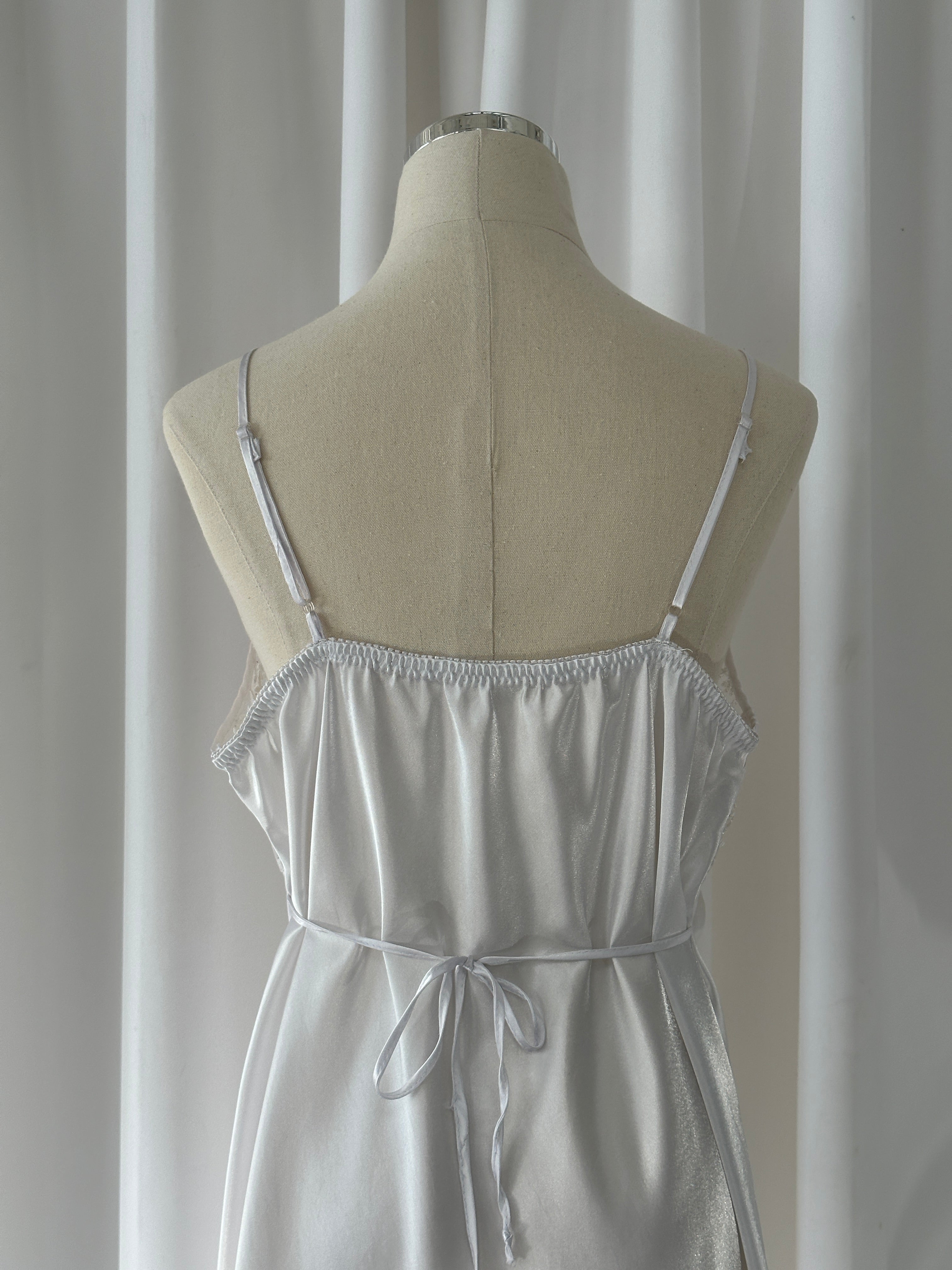 Vintage 1990s lace sheer mini slip dress in M/L, featuring delicate lace fabric and a vintage-inspired style.