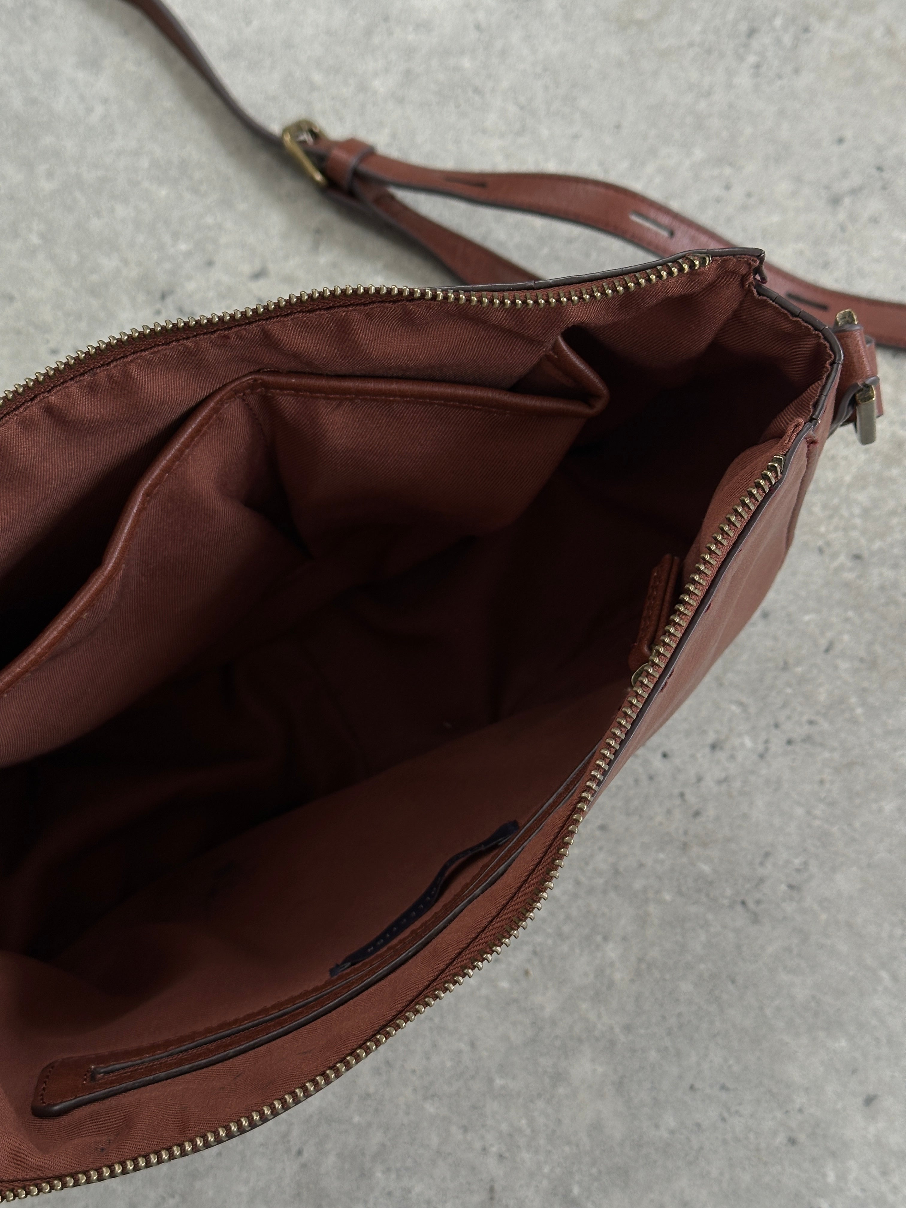 Vintage faux leather crescent crossbody bag with adjustable strap and modern design, perfect for casual and stylish wear.