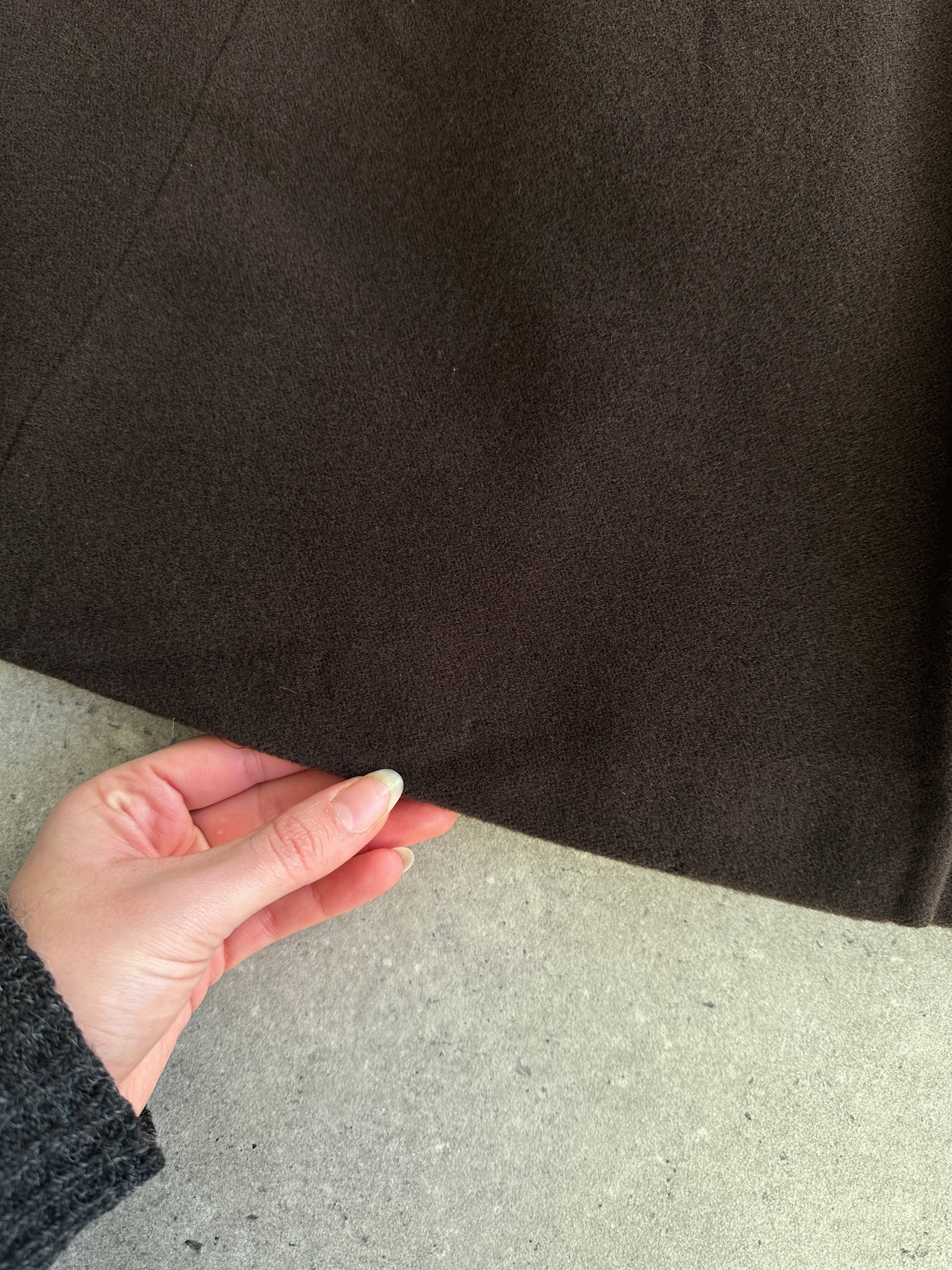 Max Mara pure wool A-line floor-length coat in size M, shown hanging on a wooden hanger. Elegant and classic design.