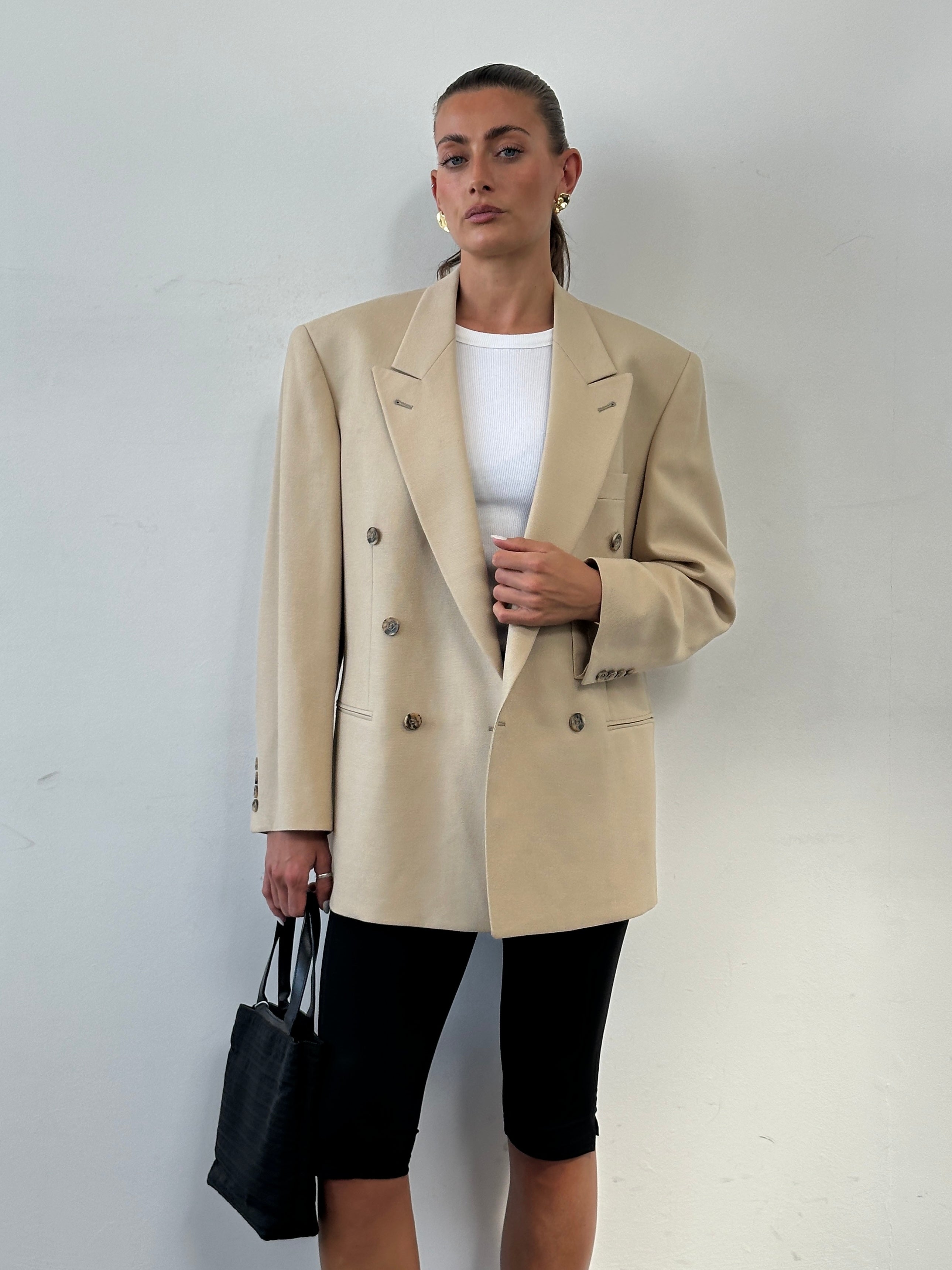 Vintage wool double-breasted blazer in size 40R/L, featuring classic tailored style and timeless design.