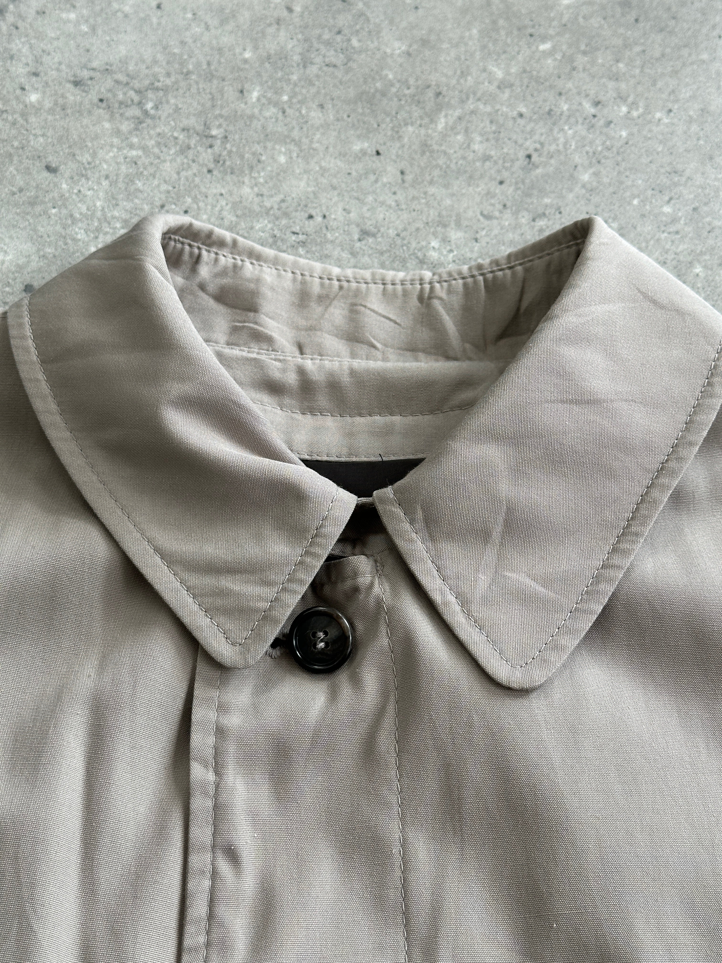 London Fog 1990s cotton single-breasted trench coat in XL size, showing the beige fabric, classic collar, and button details.