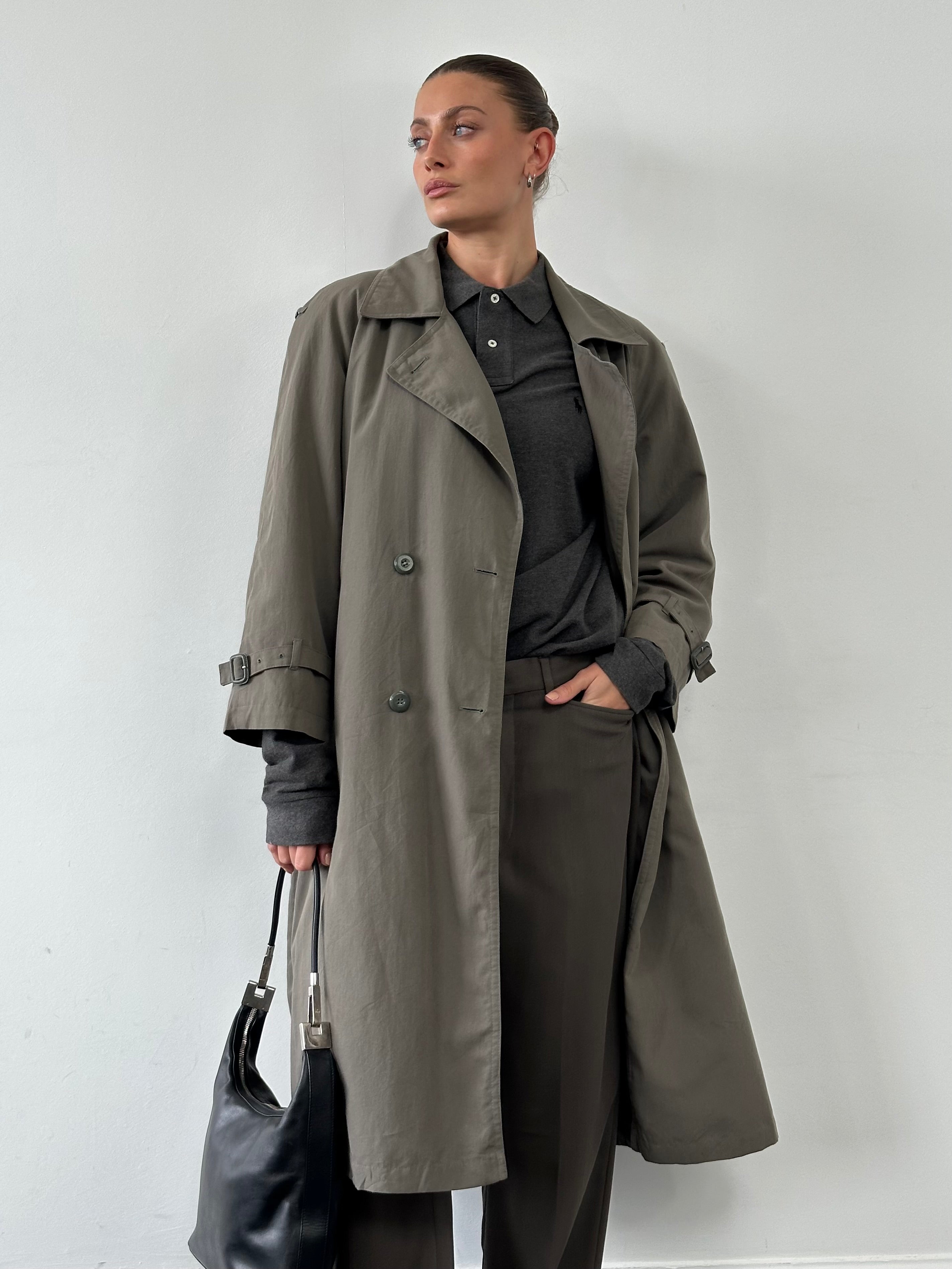 London Fog double-breasted trench coat in S/M displayed on a hanger, featuring classic design and beige color.
