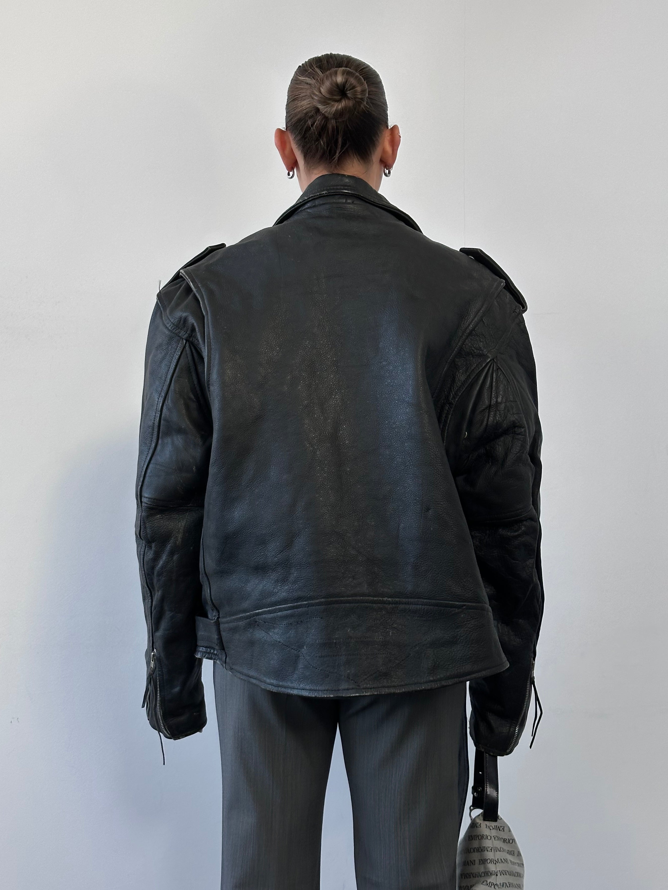 Vintage leather biker jacket in XL size, featuring classic design with distressed detailing and metal hardware.