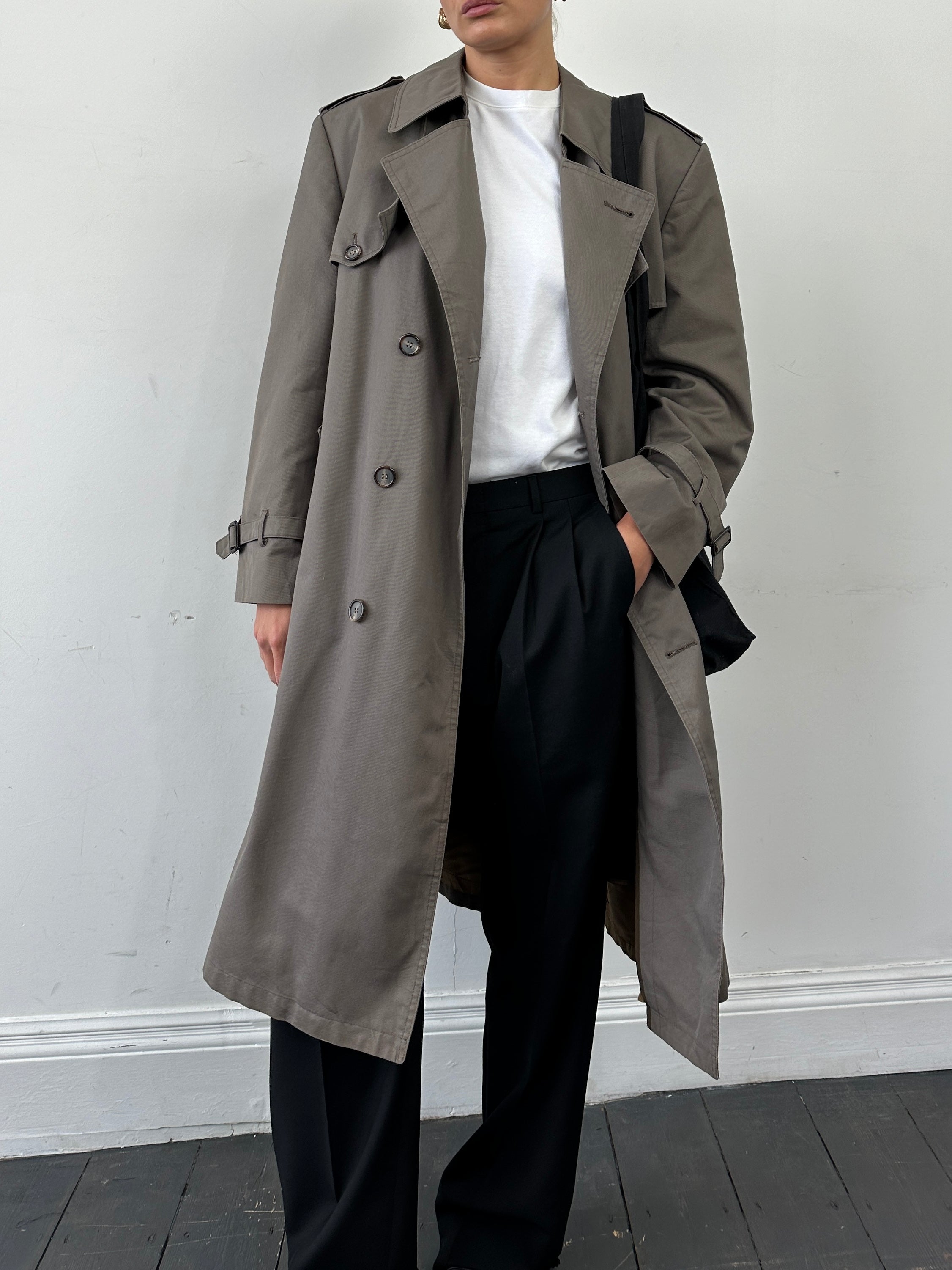 Christian Dior Monsieur double-breasted belted trench coat in classic beige, showing front view with lapels and belt.