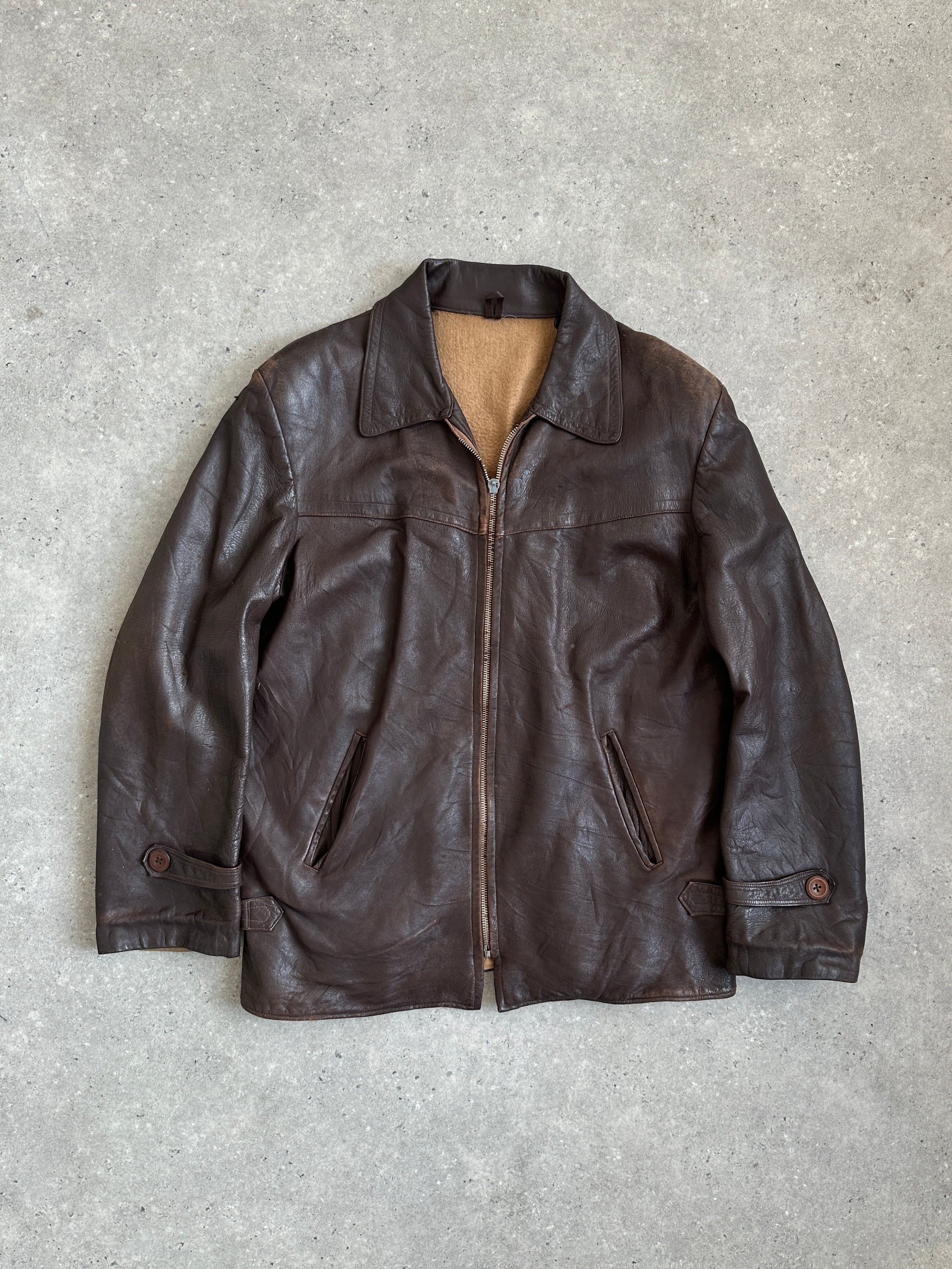 Vintage distressed mid-length leather jacket in XL size with a rugged, worn-in look, featuring classic leather design and detailing.