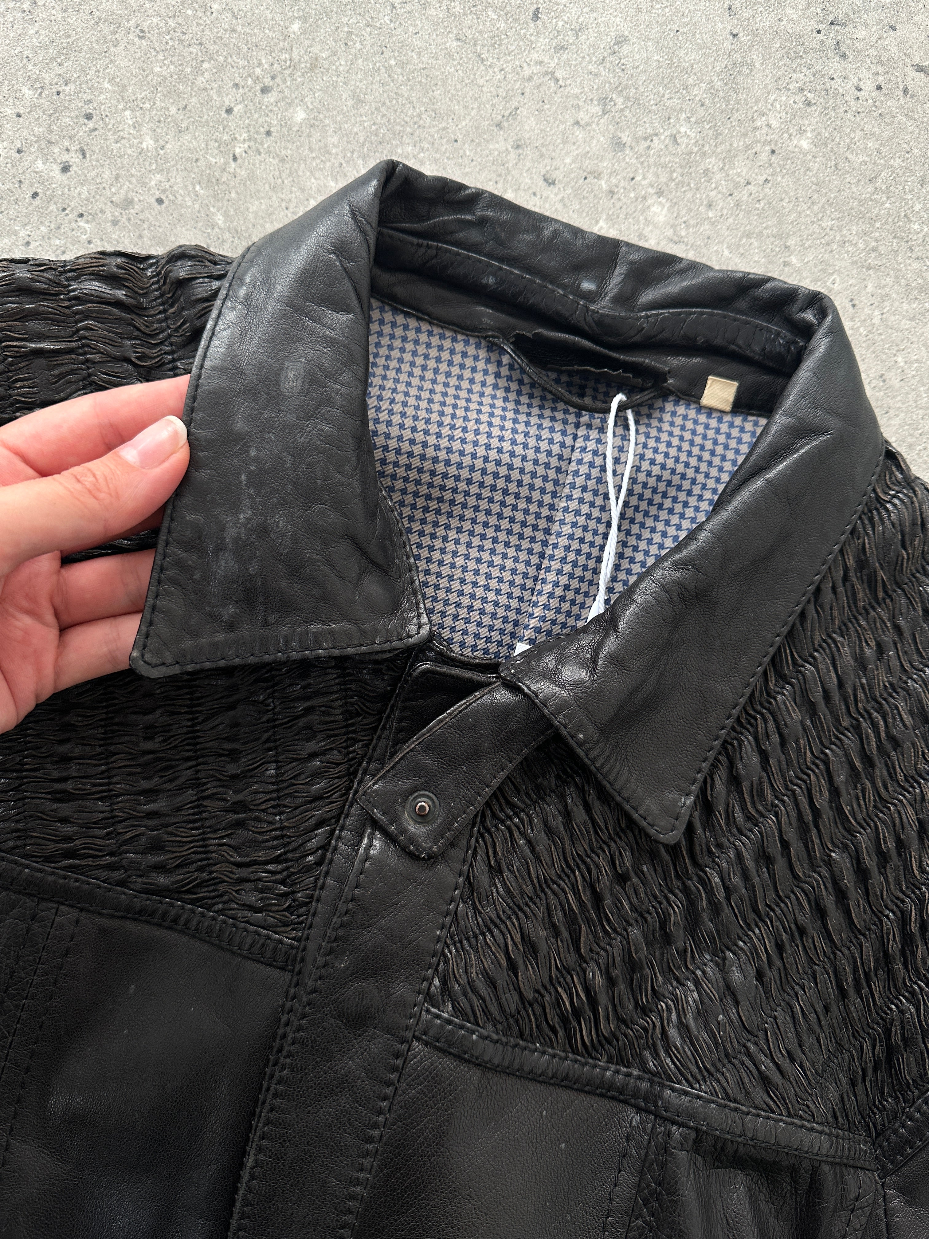 Vintage ruched leather jacket in size M, featuring stylish detailing and classic design, displayed on a hanger.