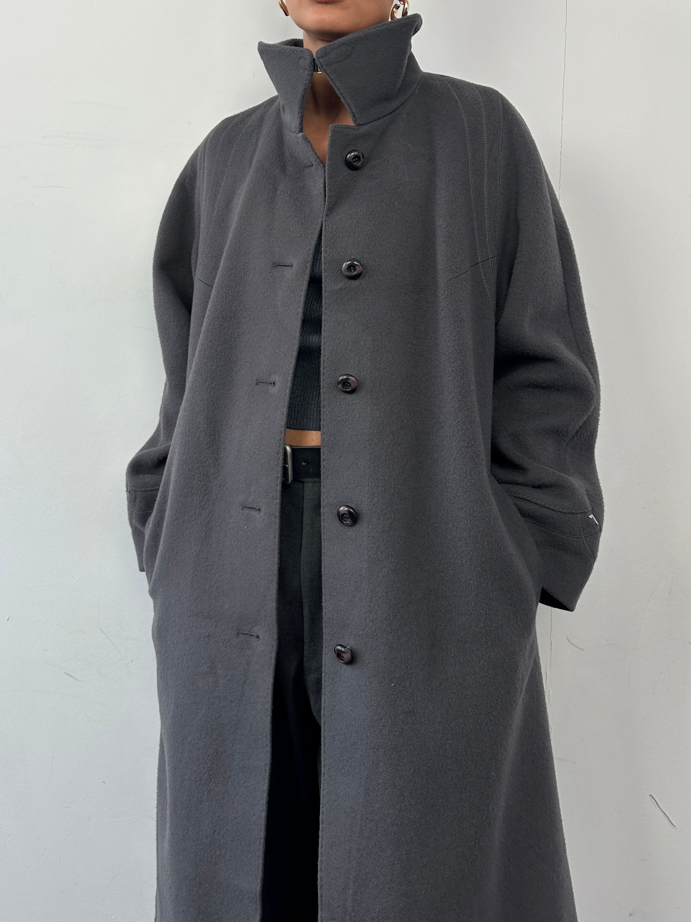 Vintage brand wool single-breasted coat in size M, featuring classic design and tailored fit, shown on a hanger.