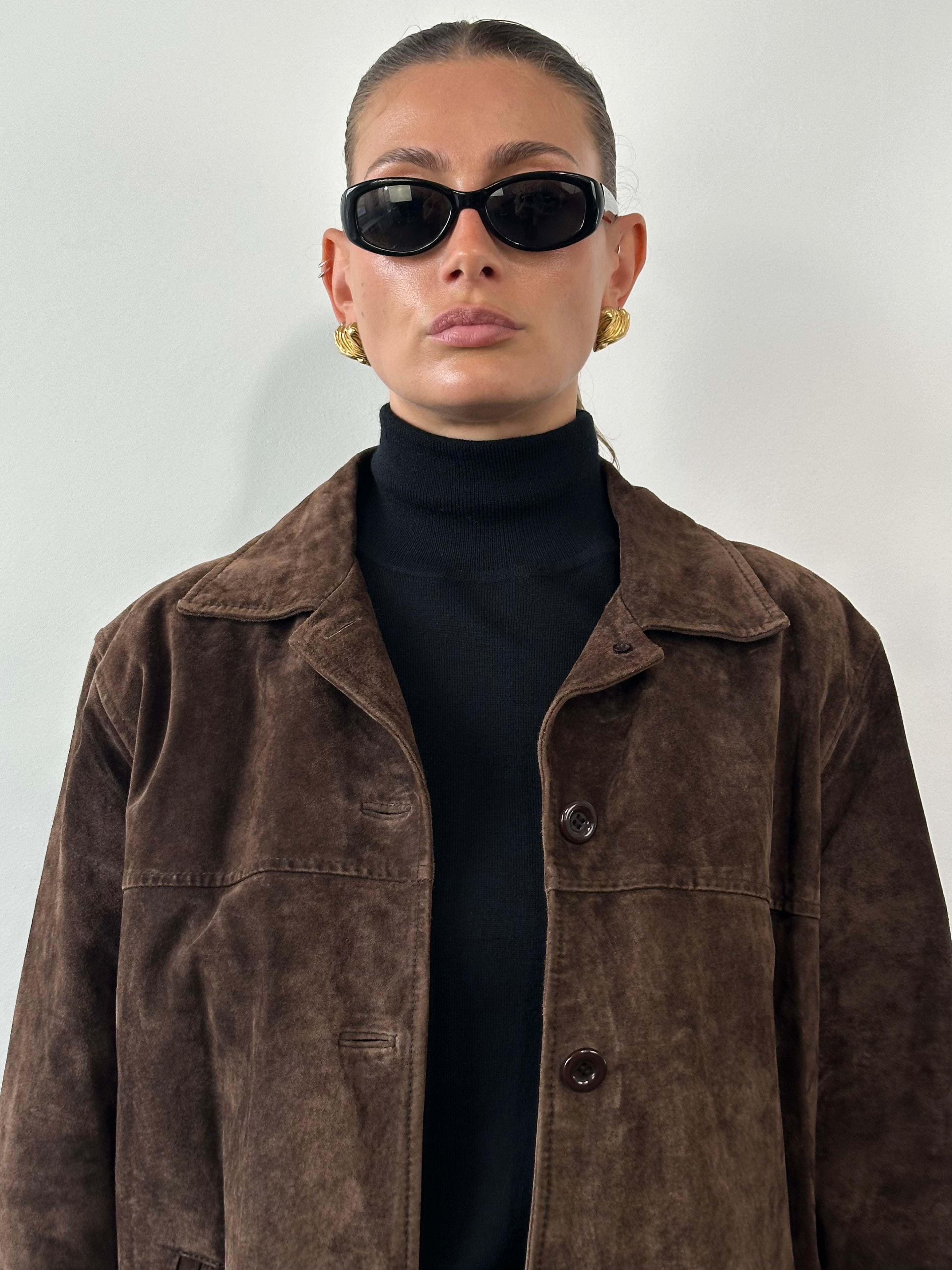 Vintage suede leather jacket in size L, featuring classic design and detailed stitching, displayed on a neutral background.