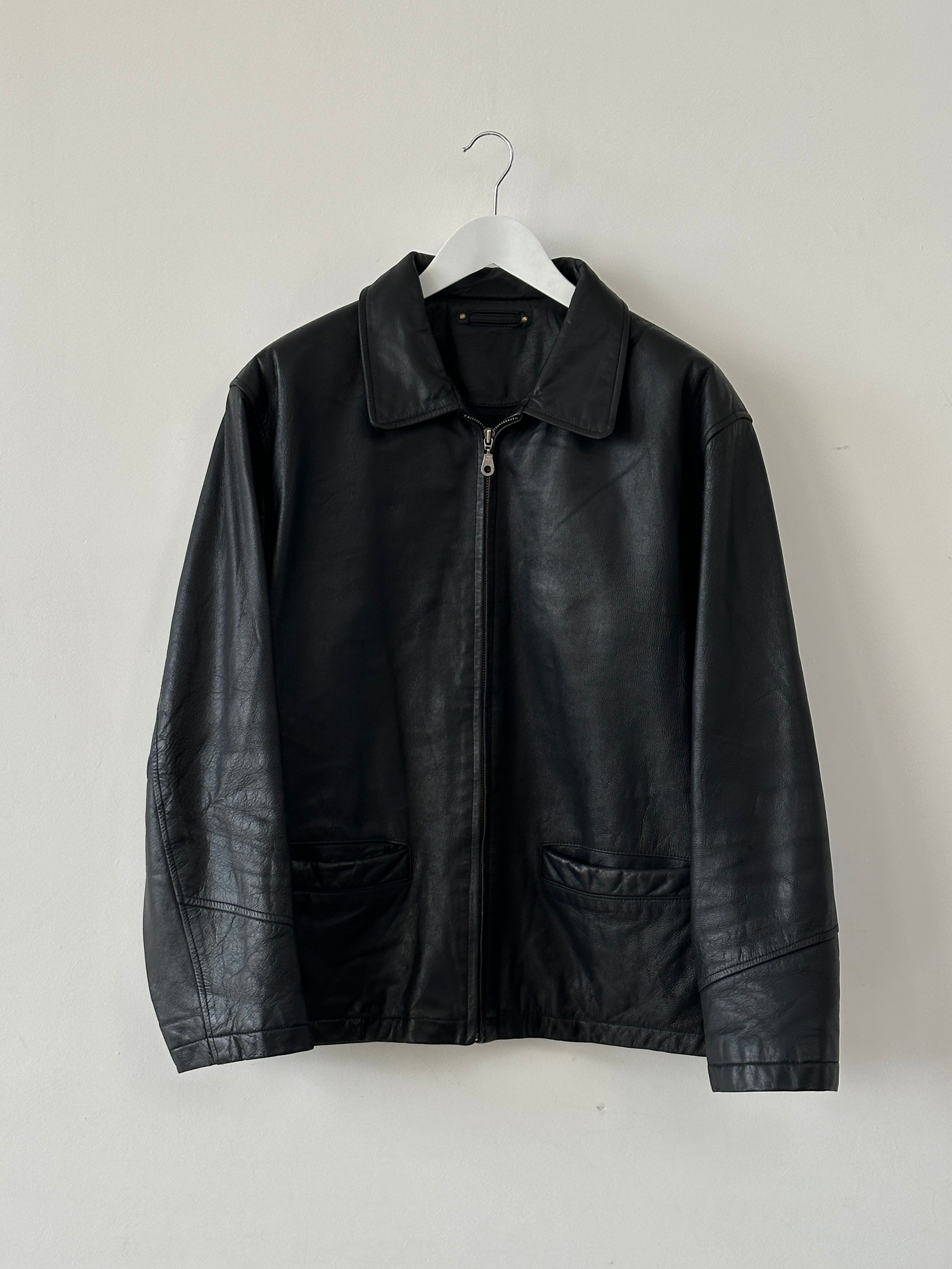 Vintage leather bomber jacket in XL size, showcasing classic design with brown leather and ribbed cuffs.