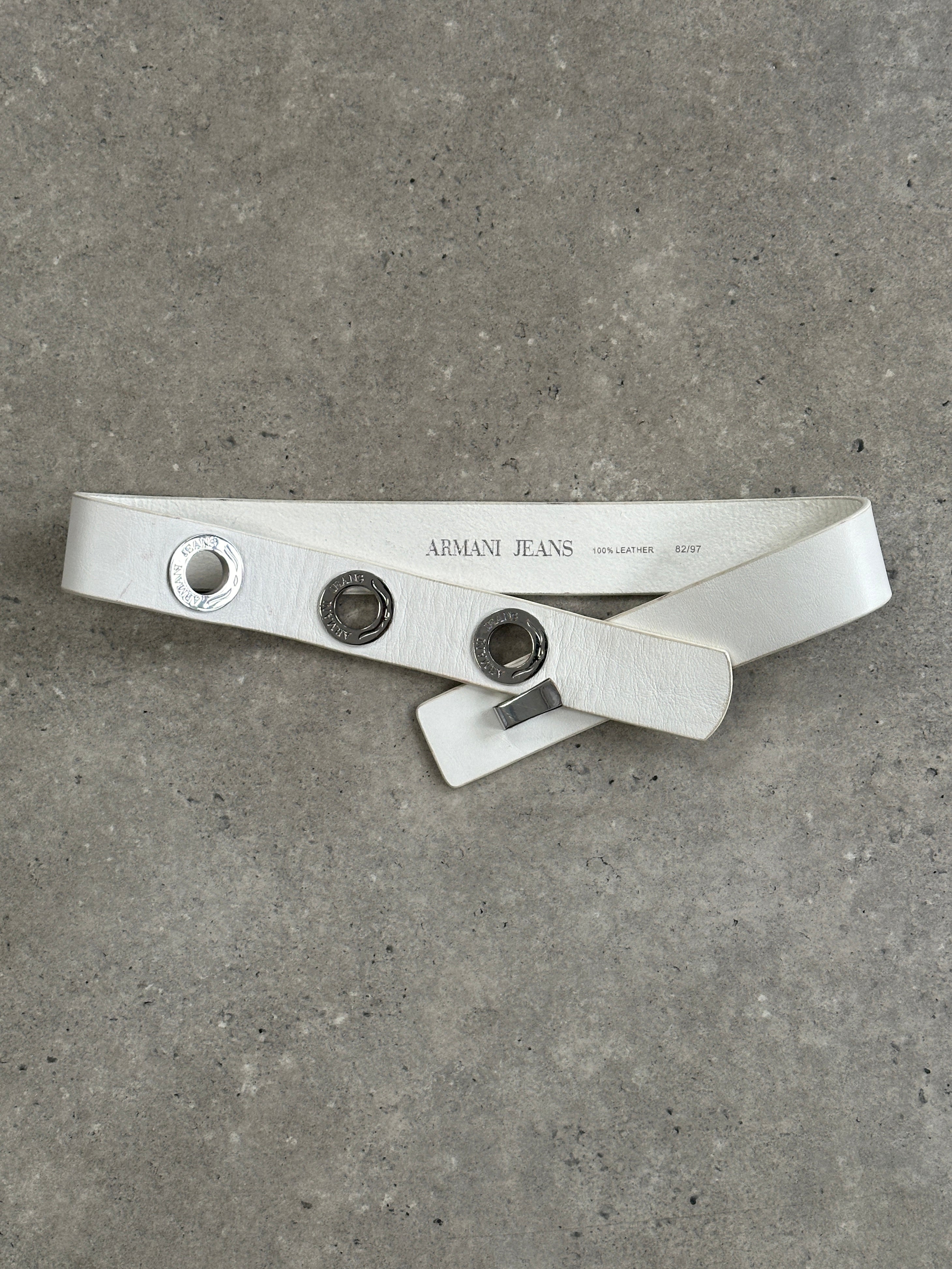 Armani Jeans silver leather belt with eyelet logo detail, size W26-32, featuring a sleek, stylish design and metallic accents.