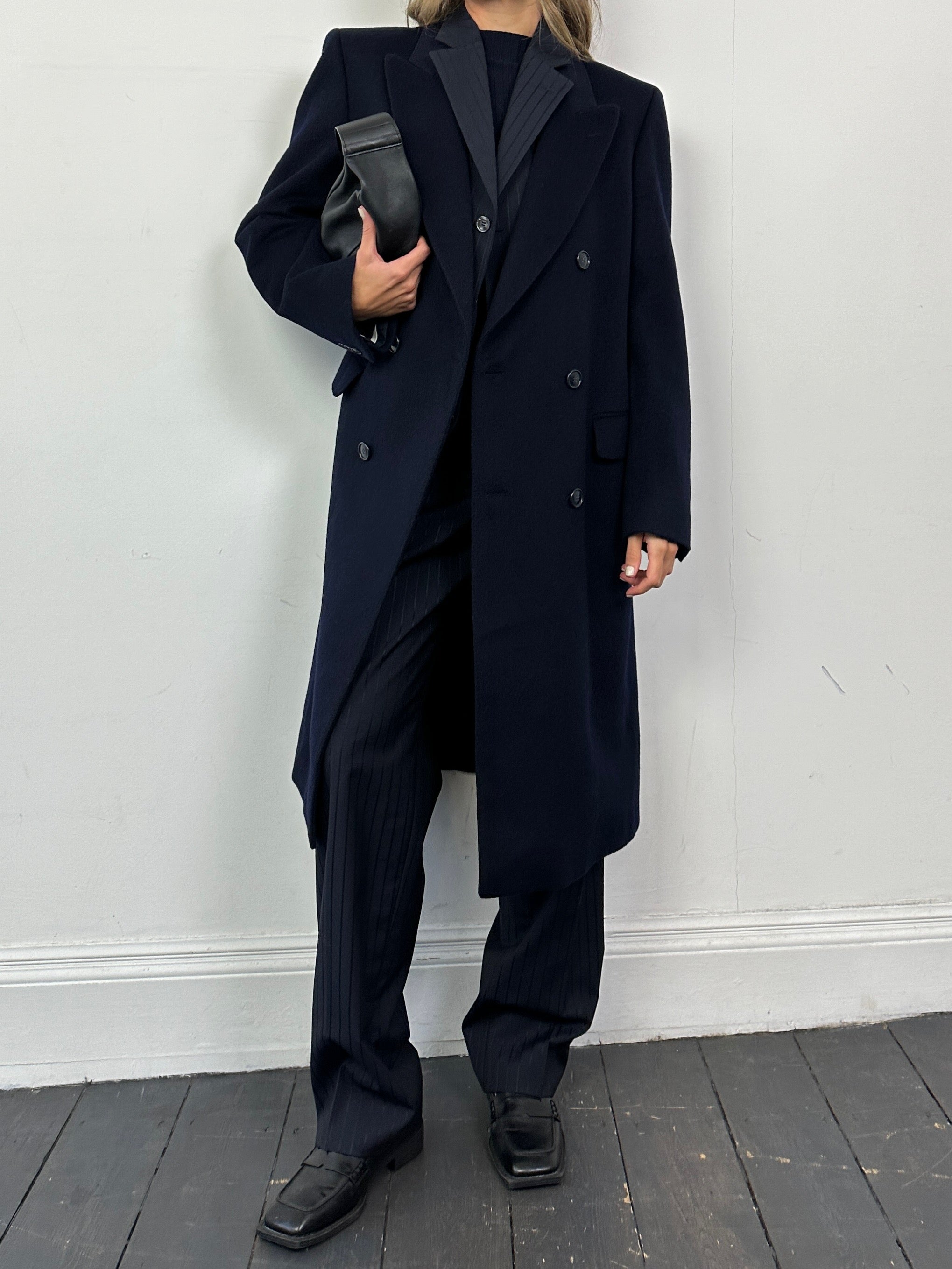 Vintage pure virgin wool double-breasted coat in M/L size, displayed on a hanger with classic tailored details and a neutral background.