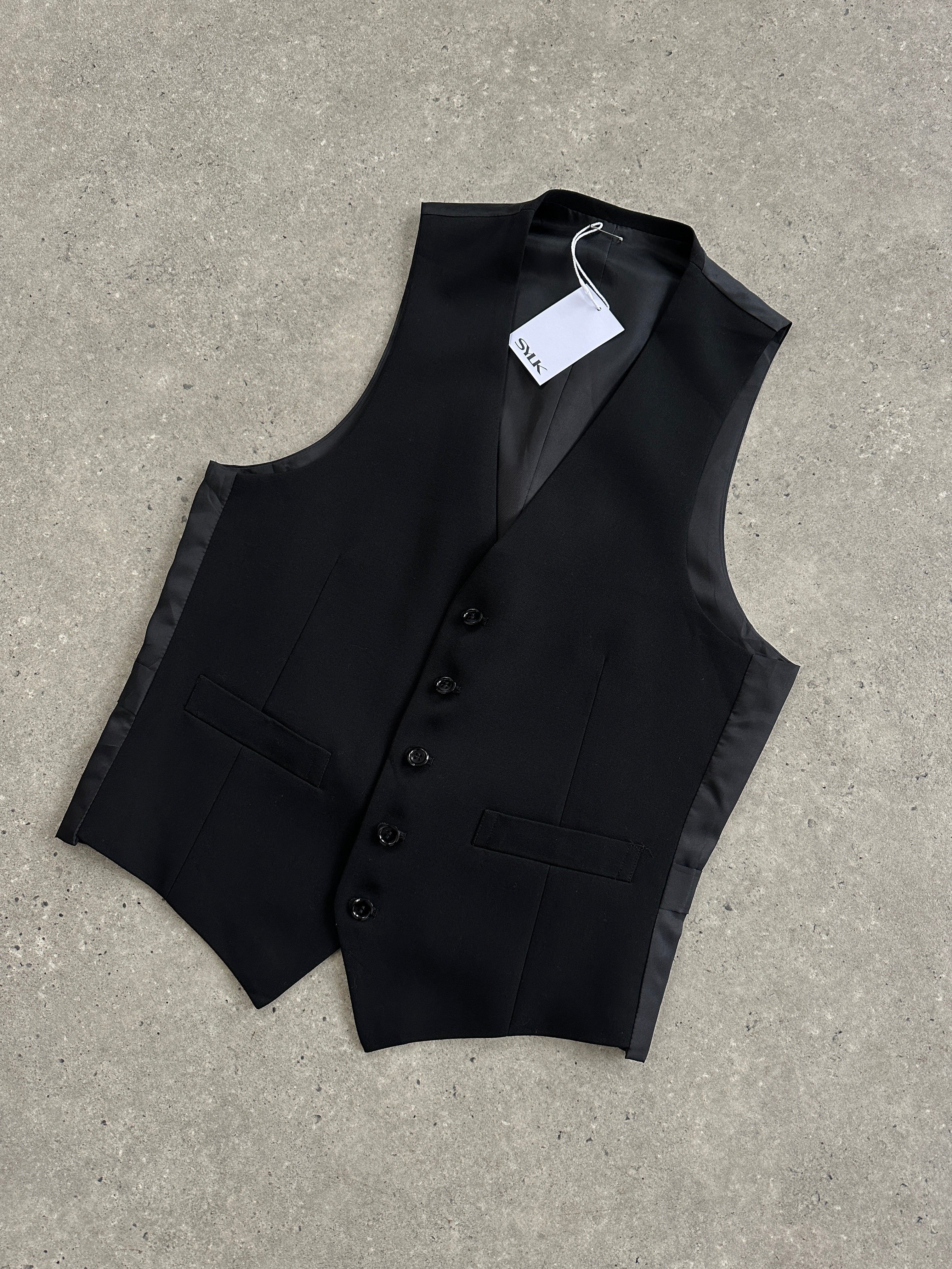 Vintage pure wool tailored waistcoat in size small, featuring classic design and detailed stitching.