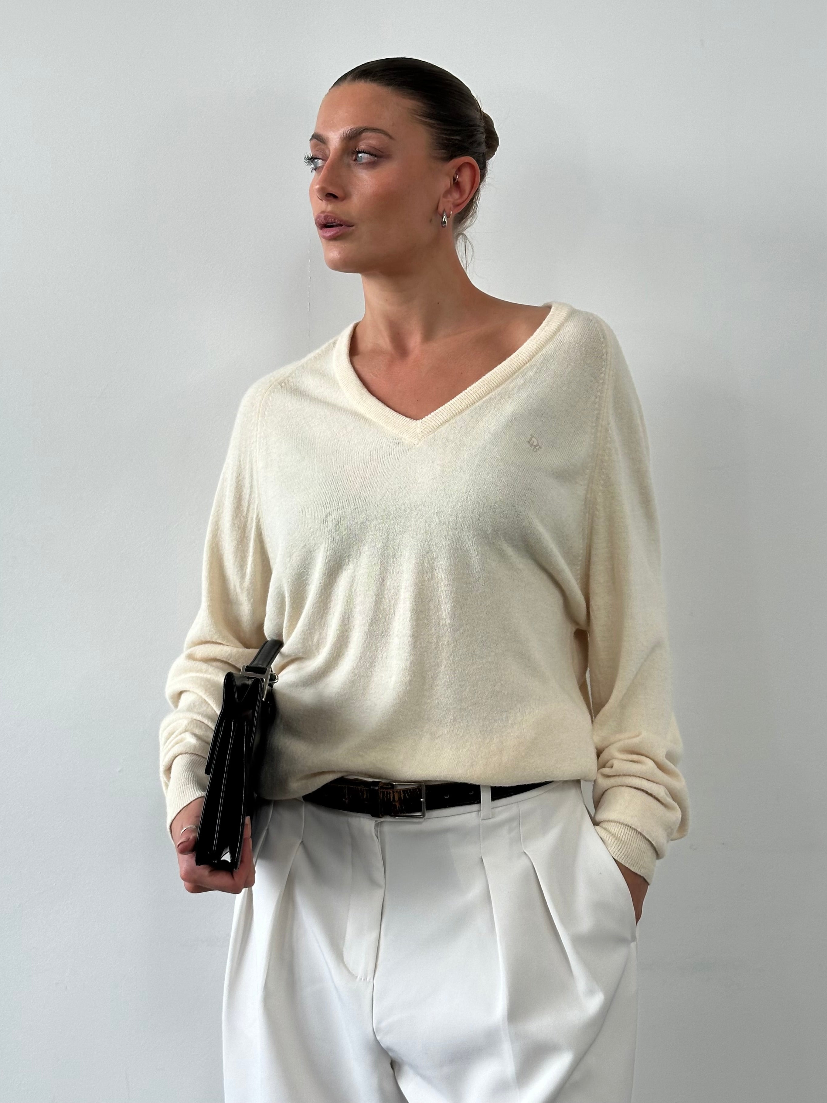 Christian Dior 1980s V-neck logo knitted jumper in size L/XL, featuring a classic design with Dior branding and a cozy knit texture.